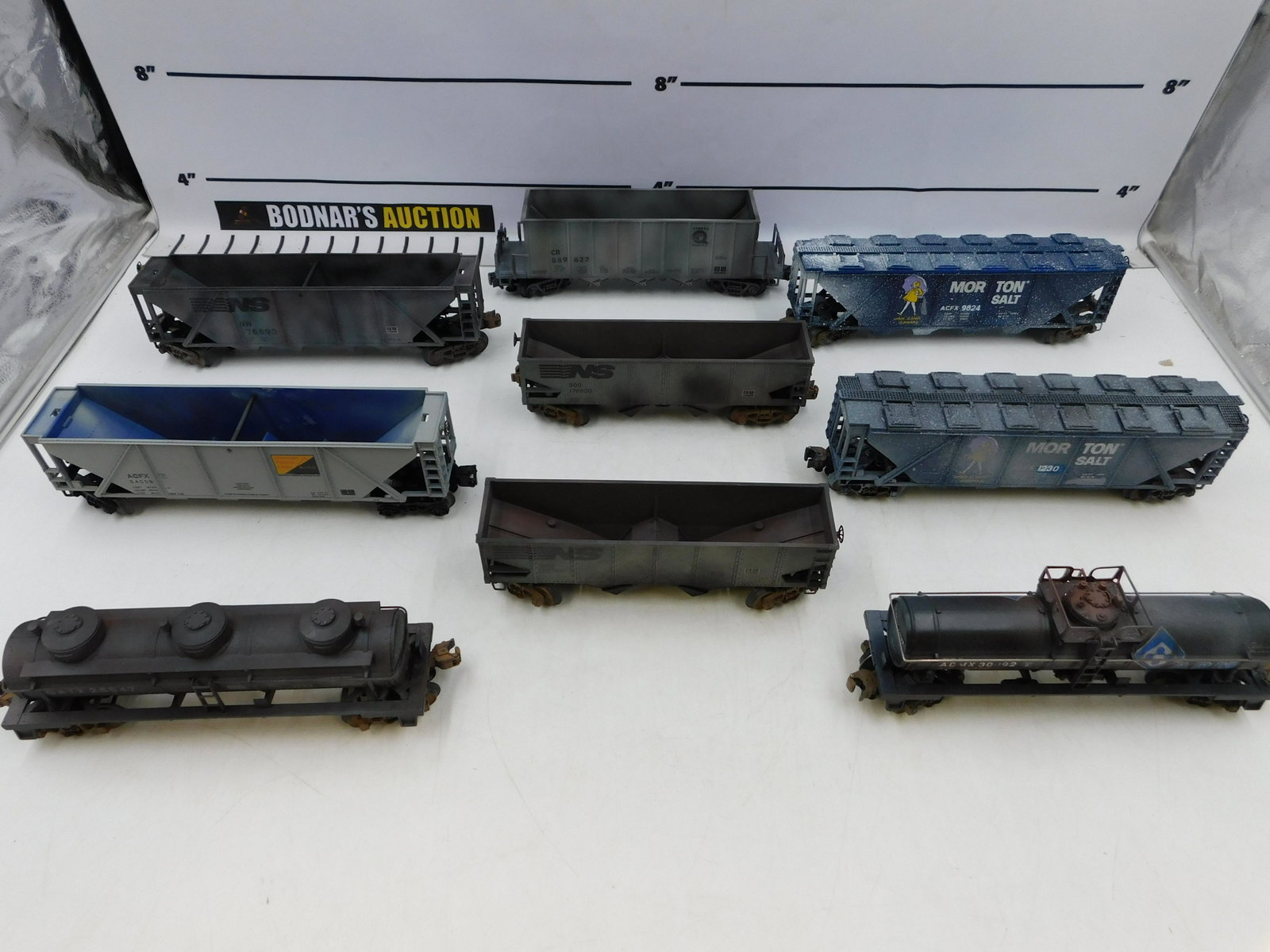 Lot of 9 O Gauge Weathered Freight Cars: Lot of 9 O Gauge Weathered Freight Cars including (2) Morton Salt Covered Hoppers, (5) Hopper Cars - 3 are Norfolk Southern, 1 Conrail, and 1 ACFX, and 2 Tank Cars. Please read the terms and condition