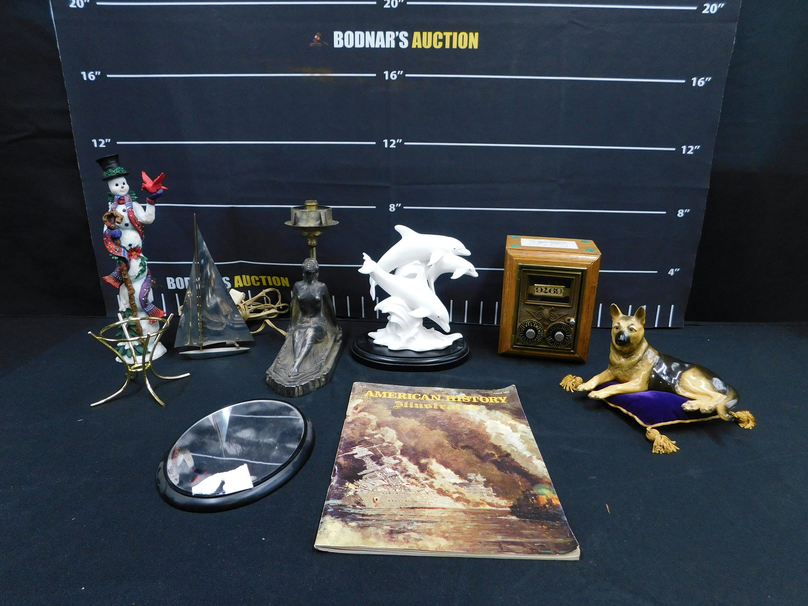 Group Lot including Lenox and Art Deco: Group Lot including Art Deco Nude Woman Lamp Base, Lenox Dolphins, Lenox Snowman, Morton Studios German Shepard figurine with Chips, Post Office Box Bank, and More. All invoices must be paid within 24