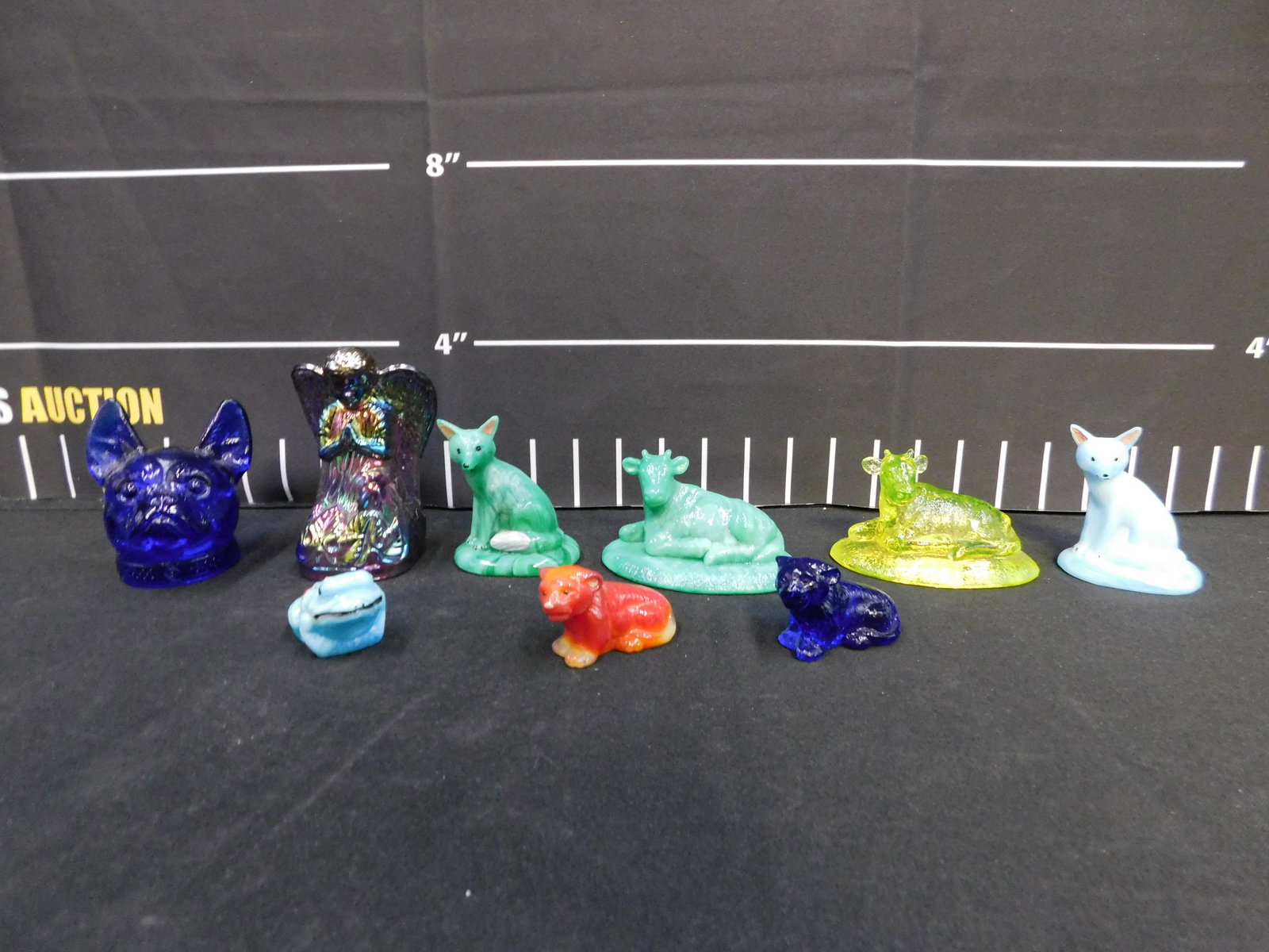 Lot of Boyds Glass Figurines: Lot of Boyds Glass Figurines including Angel, Dog Bust, Wolf, Cow, Frog, and More. The largest measures 4.5" tall x 2.5" wide. All invoices must be paid within 24 hours of the sale. This auction is Lo