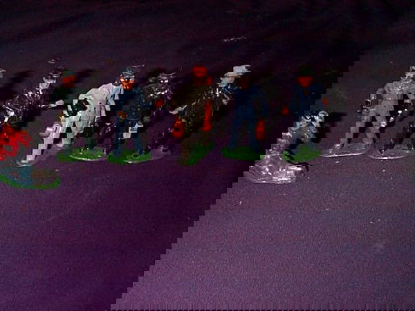 Lot of 6 cast-iron figurines including Barclay #52: Lot of 6 cast-iron figurines including Barclay #522, train mechanic, train conductor, train police officer, black memorabilia train attendant, and black memorabilia luggage attendant carrying golf clu