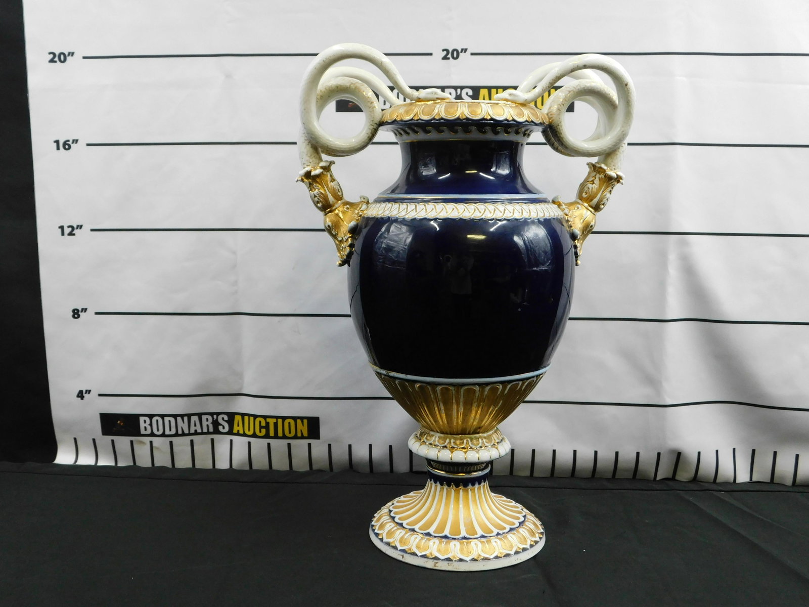 19th Century Porcelain Vase with Serpent Handles: 19th Century Porcelain Vase with Serpent Handles. Has a marking on the bottom - appears to be Meissen. Measures 19" tall x 14" wide x 10" deep. All invoices must be paid within 24 hours of the sale. T