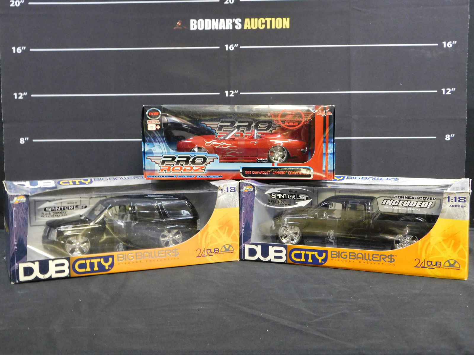 Lot of 3 Jada and Maisto 1:18 Scale Diecast Cars: Lot of 3 Jada and Maisto 1:18 Scale Diecast Cars including (2) Dub City Big Ballers Cadillac Escalades and Maisto Pro Rodz 1968 Chevrolet Camaro Convertible. All come in original boxes. Please read th