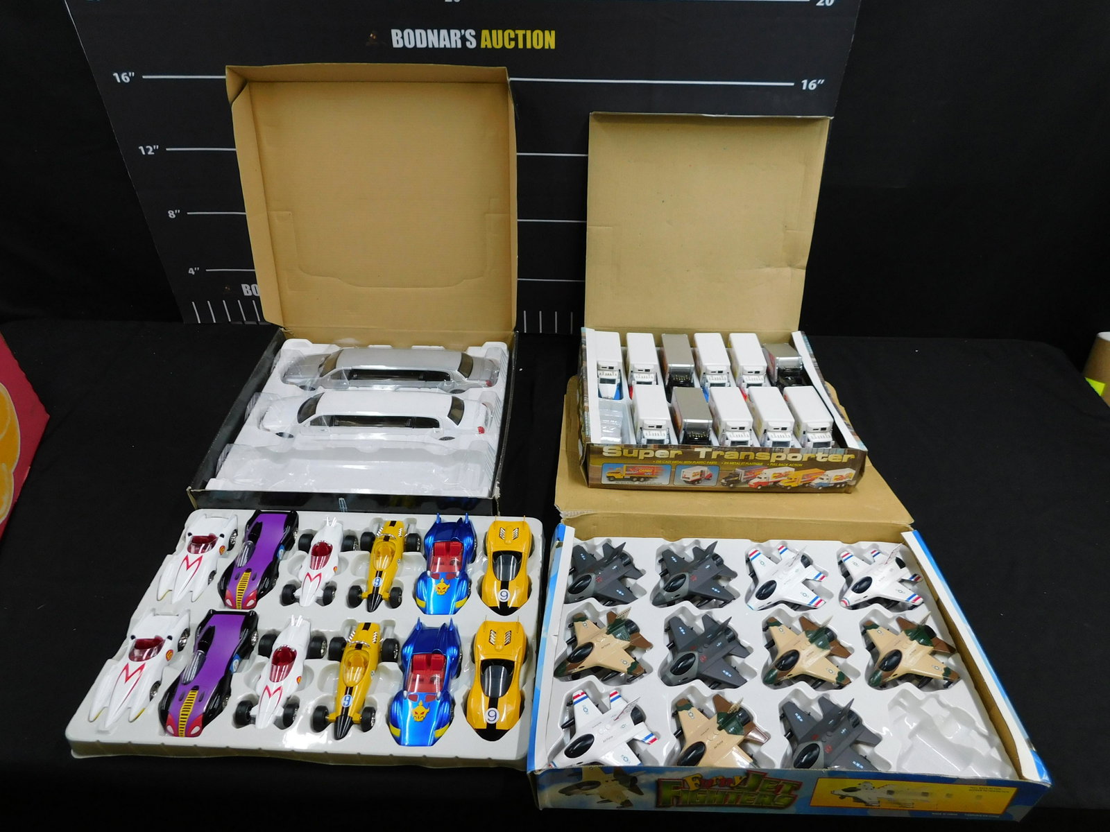 Mixed Lot of Diecast Vehicles: Mixed Lot of Diecast Vehicles including (2) 1:28 Scale Sunnyside Lincoln Limousine in the display box, (11) Funny Jet Fighters in the display box, (11) Super Transporter in the display box and (12) Ja