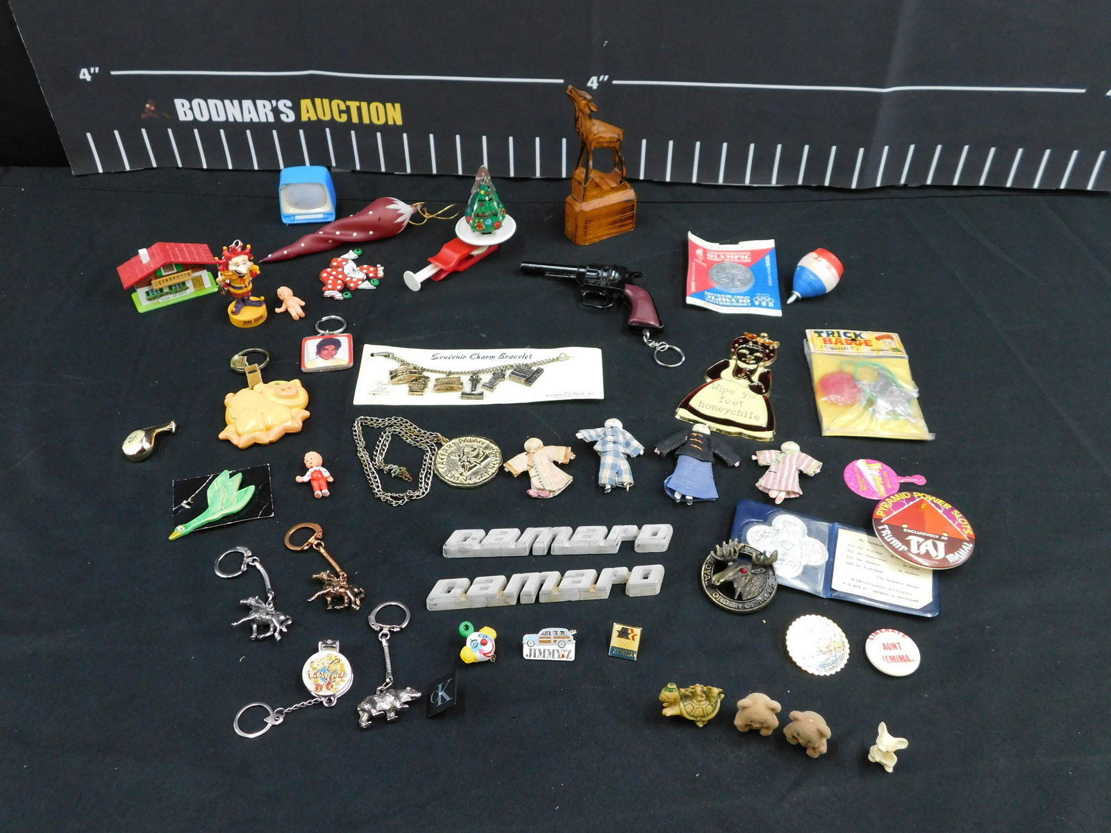 Lot of Vintage Toys and Collectibles: Lot of Vintage Toys and Collectibles including Keychains, Carved Wooden Deer, Santa, Miniature Figures, Commemorative Olympic Medallion, Ornament, and More. Please read the terms and conditions. This