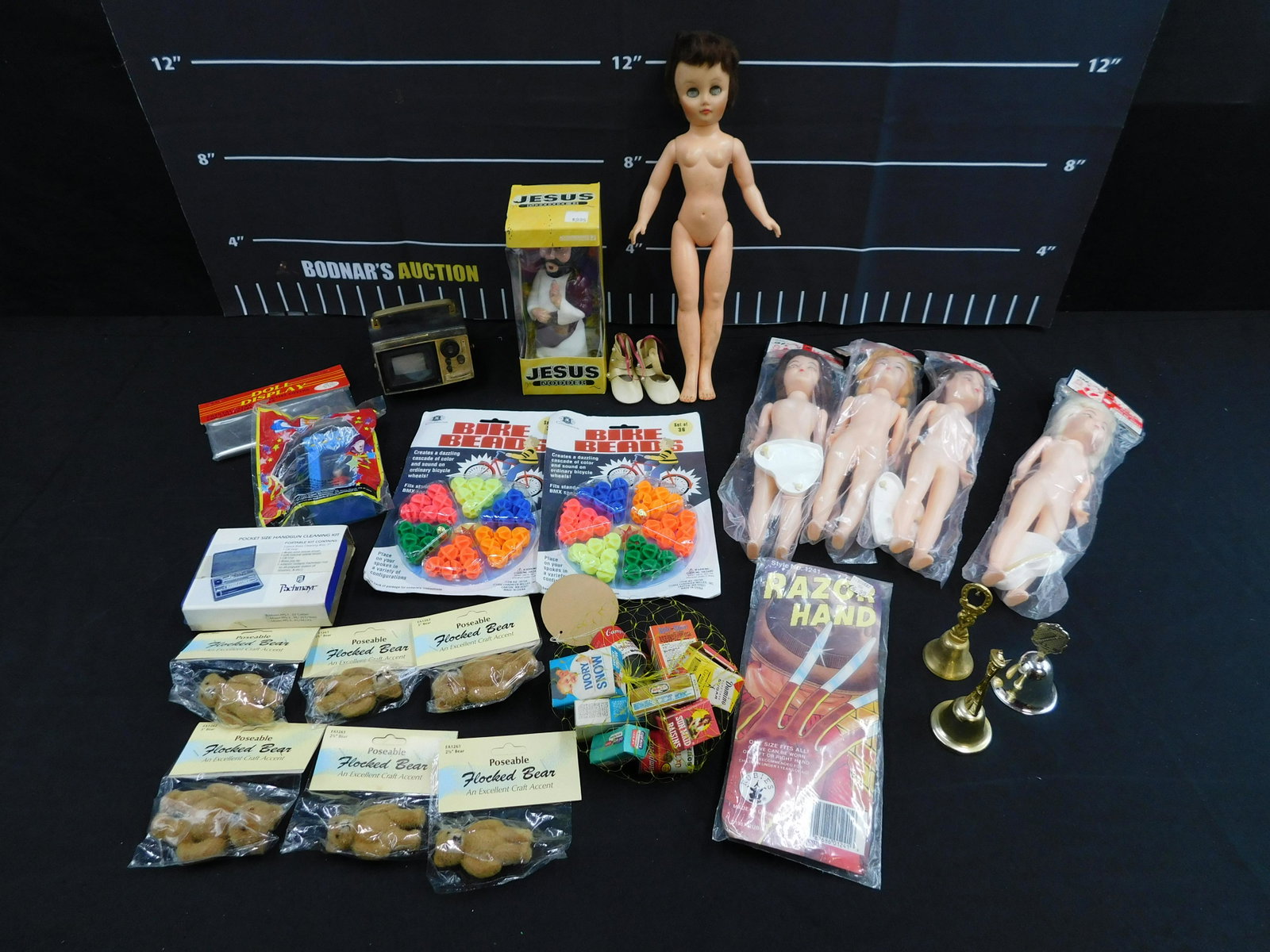 Lot of Mixed Toys and Collectibles: Lot of Mixed Toys and Collectibles including Dress Me Dolls, Bike Beads, Jesus Nodder, Miniature Bag of Food Advertisements and More. Please read the terms and conditions. This sale will be broadcast 