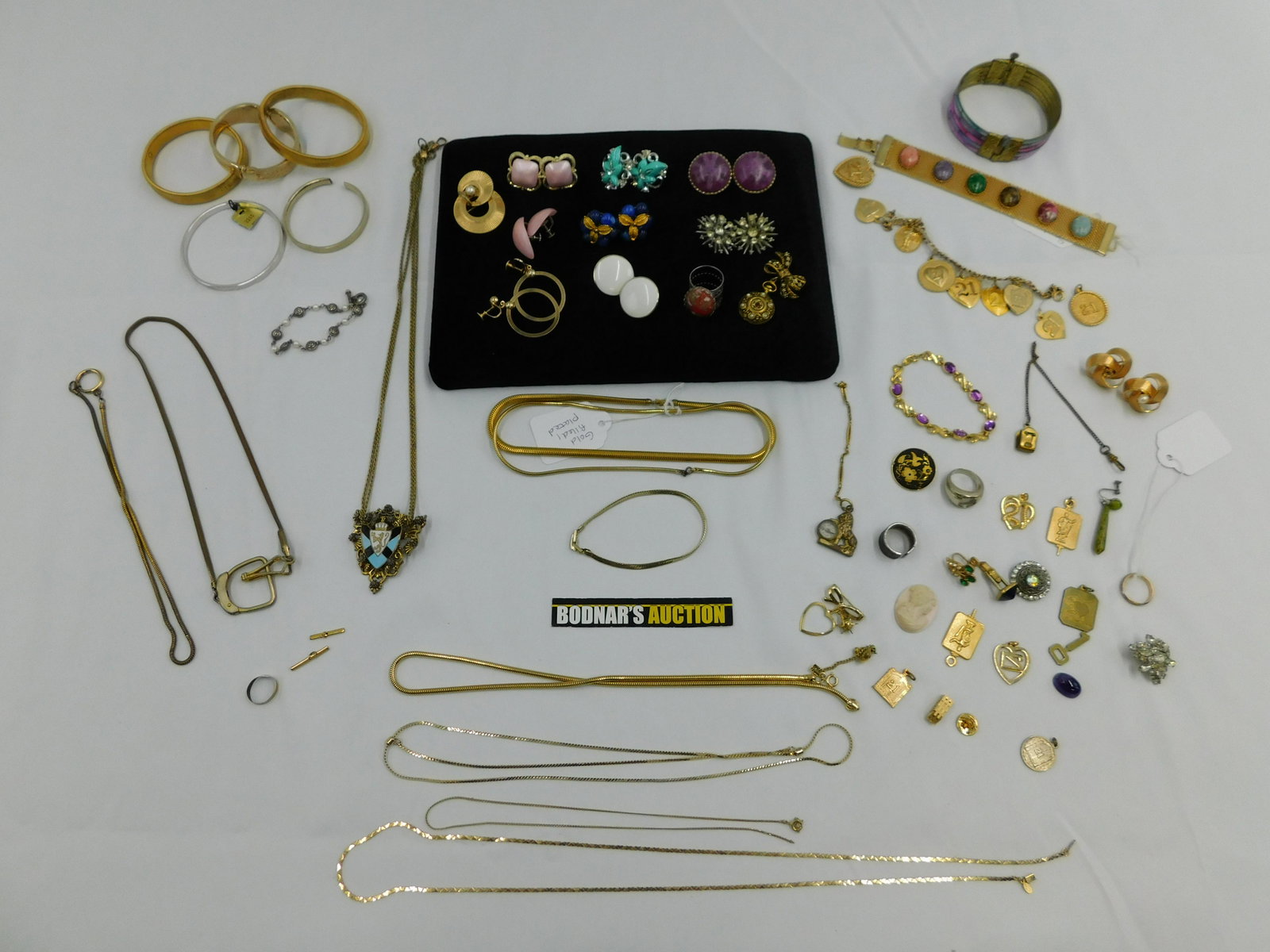 Lot of Gold and Silver Toned Costume Jewelry: Lot of Gold and Silver Toned Costume Jewelry including Enamel Pieces, Sarah Coventry Sonnet Bracelet, Many Earrings, Necklaces and Gold Filled/Plated Jewelry. Some pieces are missing stones or broken.