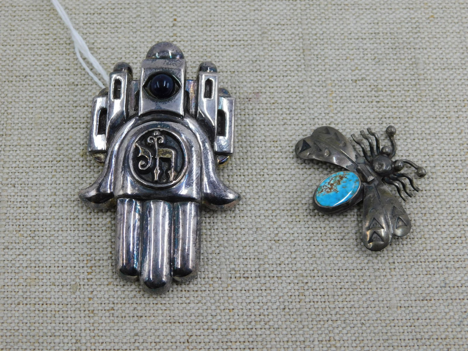 Lot of 2 Sterling Silver Pins: Lot of 2 sterling silver pins including an Israel style pin/pendant with a dark stone marked Frank Meisler, Israel and a bee pin with turquoise. Measures approx. 1 1/4" - 2 1/2".All invoices must be p