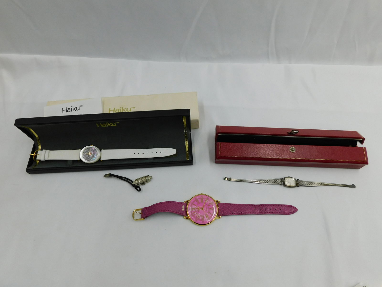 Lot of 3 Watches: Lot of 3 Watches including Haiku - Leather Band with Abalone face, Sterling Silver Sable Watch, and Fashion Watch with Pink Face and Pink Leather Band - Some loss to leather. Also included is a Waltha