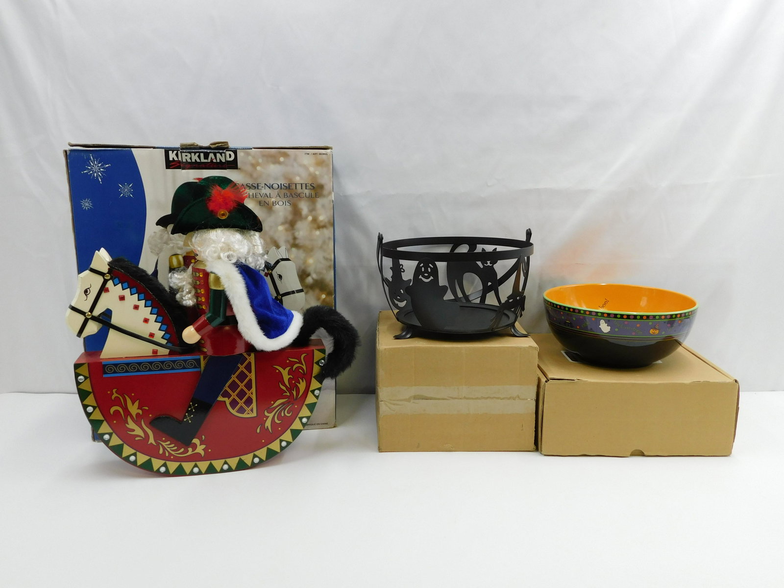Lot of Holiday Decorations: Lot of Holiday decorations including Longaberger Halloween part bowl No 31805 with box, Longaberger Wi-Large Cauldron Holder No 71453 in box and Kirkland Nutcracker rocking horse with box largest meas
