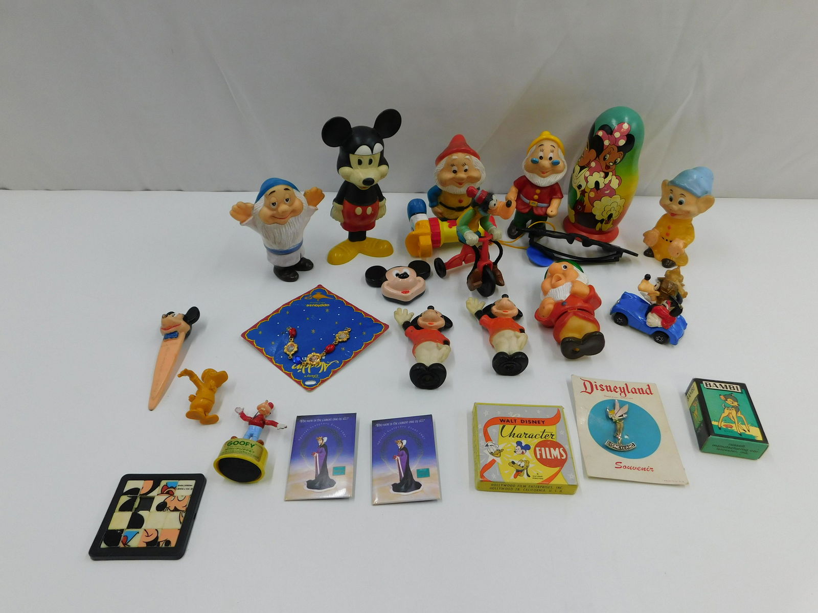 Lot of Vintage Disney Items: Lot of Vintage Disney Items including Russian Nesting Dolls, Plastic Squeaky Dwarves, Toys, and More. All invoices must be paid within 24 hours of the sale. Shipping options are the Liveaship from liv