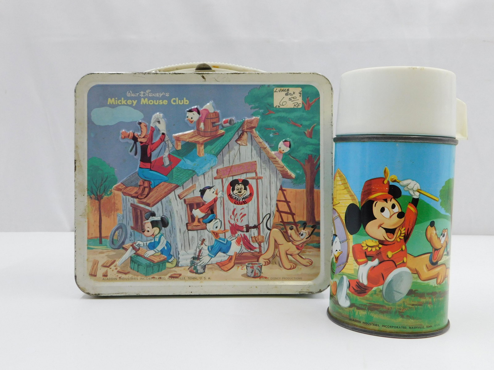 Mickey Mouse Club Lunchbox and Thermos: Walt Disney's Mickey Mouse Club vintage tin lunchbox with original Thermos and Thermos holder on the inside. Marked Aladdin Industries Incorporated, Nashville Tenn. USA. Walt Disney Productions. Has m
