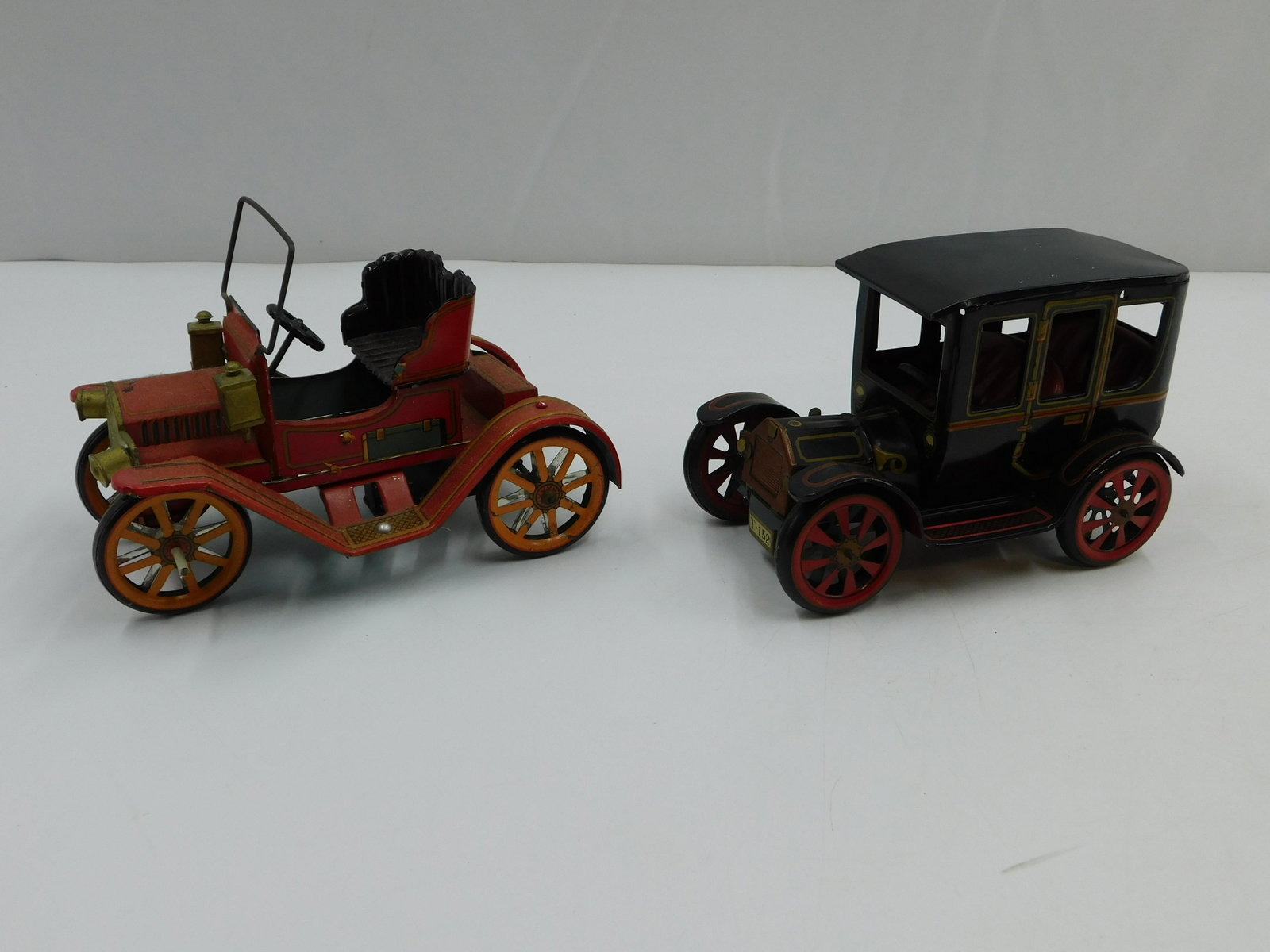 Lot of 2 Japanese Tin Plated Level Action Cars: Lot of 2 Japanese Tin Plated Level Action Cars including Model T - 152 and Convertible Model T. Both in very good condition and working. Largest measures 5" tall x 7" long. All invoices must be paid w