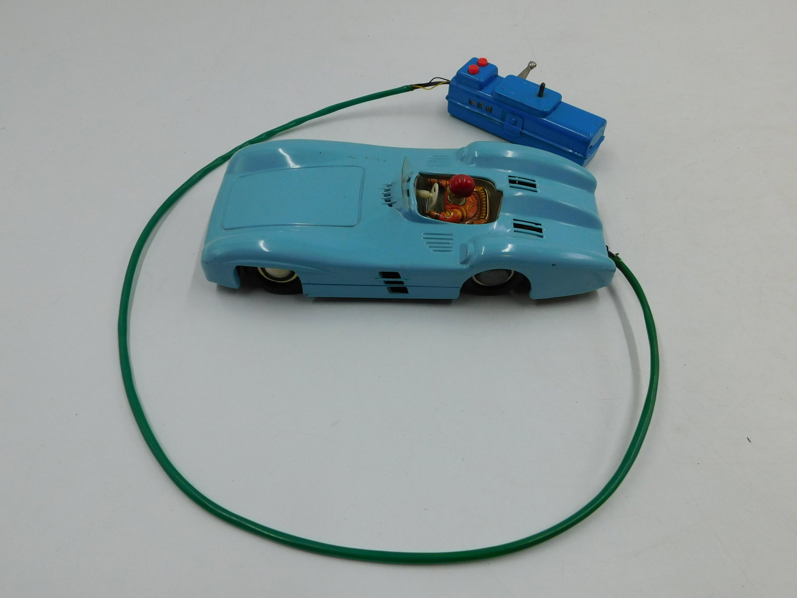 Vintage Japanese Battery Operated Racecar: Vintage Japanese Battery Operated Racecar. Tin Plating and Battery Chamber in very good to mint condition. Original steering wheel and windshield are present but loose. Rubber wheels are showing crack