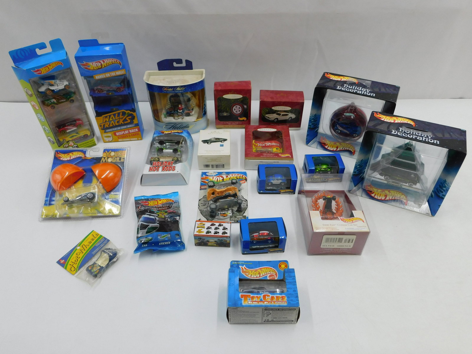 Lot of Mixed Hot Wheels Items: Lot of Mixed Hot Wheels Items including Ornaments, Yolk Mobile, Holiday Specials, Gift Packs - Missing Cars, 1:87 Scale VW Bugs, Erasers and More. Also includes a few Hallmark Ornaments - Not Hot Whee