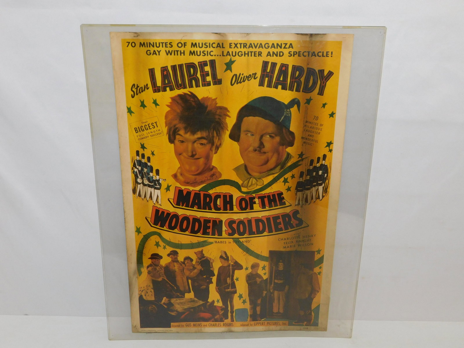 Laurel and Hardy "March of the Wooden Soldiers" Movie Poster: Vintage Laurel and Hardy "March of the Wooden Soldiers" Movie Poster. Dated 1934. Has some staining, smudges, and small tears present. Measures 28.5" tall x 20" wide. All invoices must be paid within 