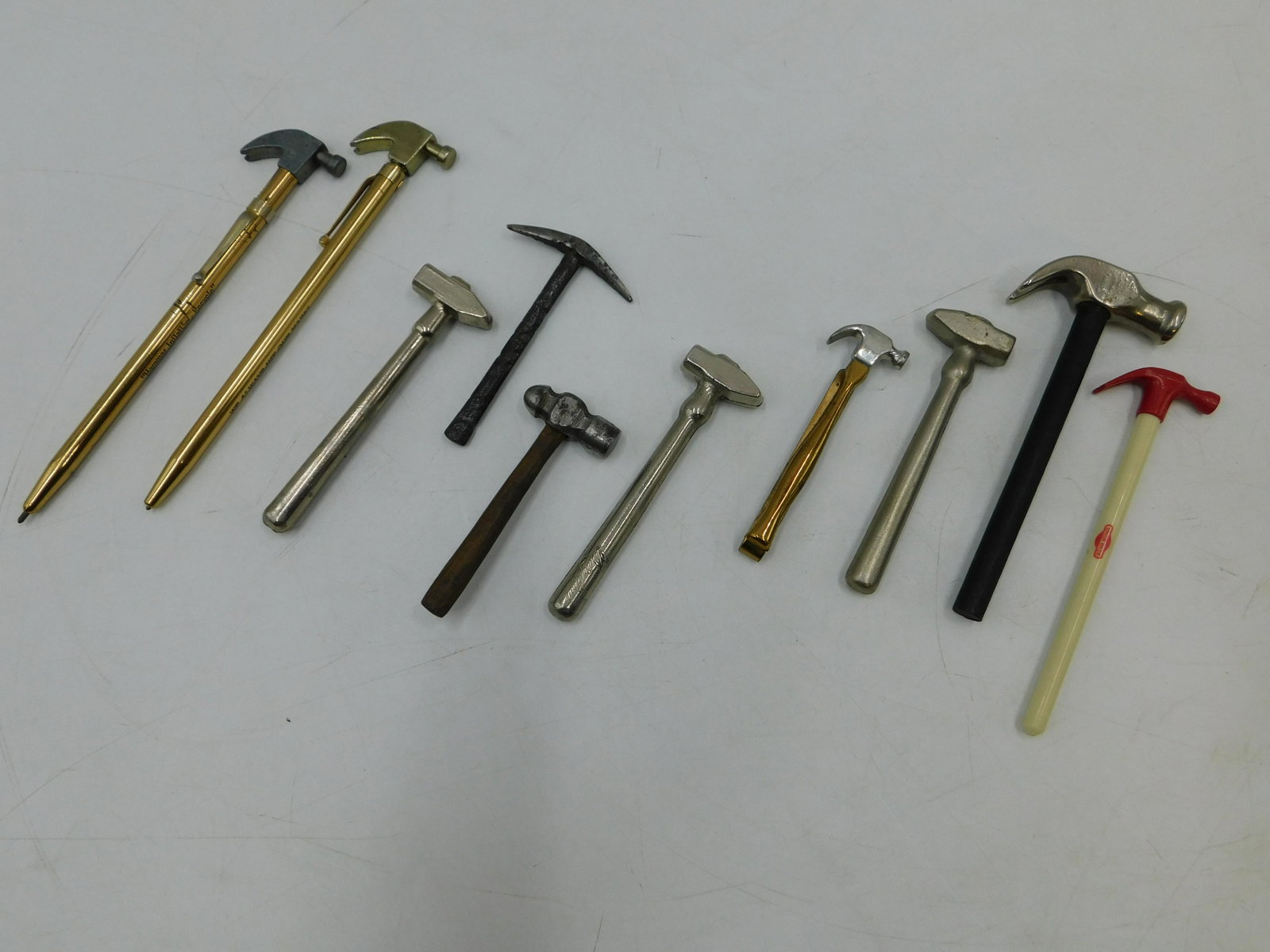 Lot of 10 Miniature Hammers and Picks: Lot of 10 Miniature Hammers and Picks. Including 2 Promotional Pens, Elect Morgan Smith Plastic Promotion, Tie Clasp, Advertisement for See's Candies, and More. Largest measures 5.5" long. All invoice