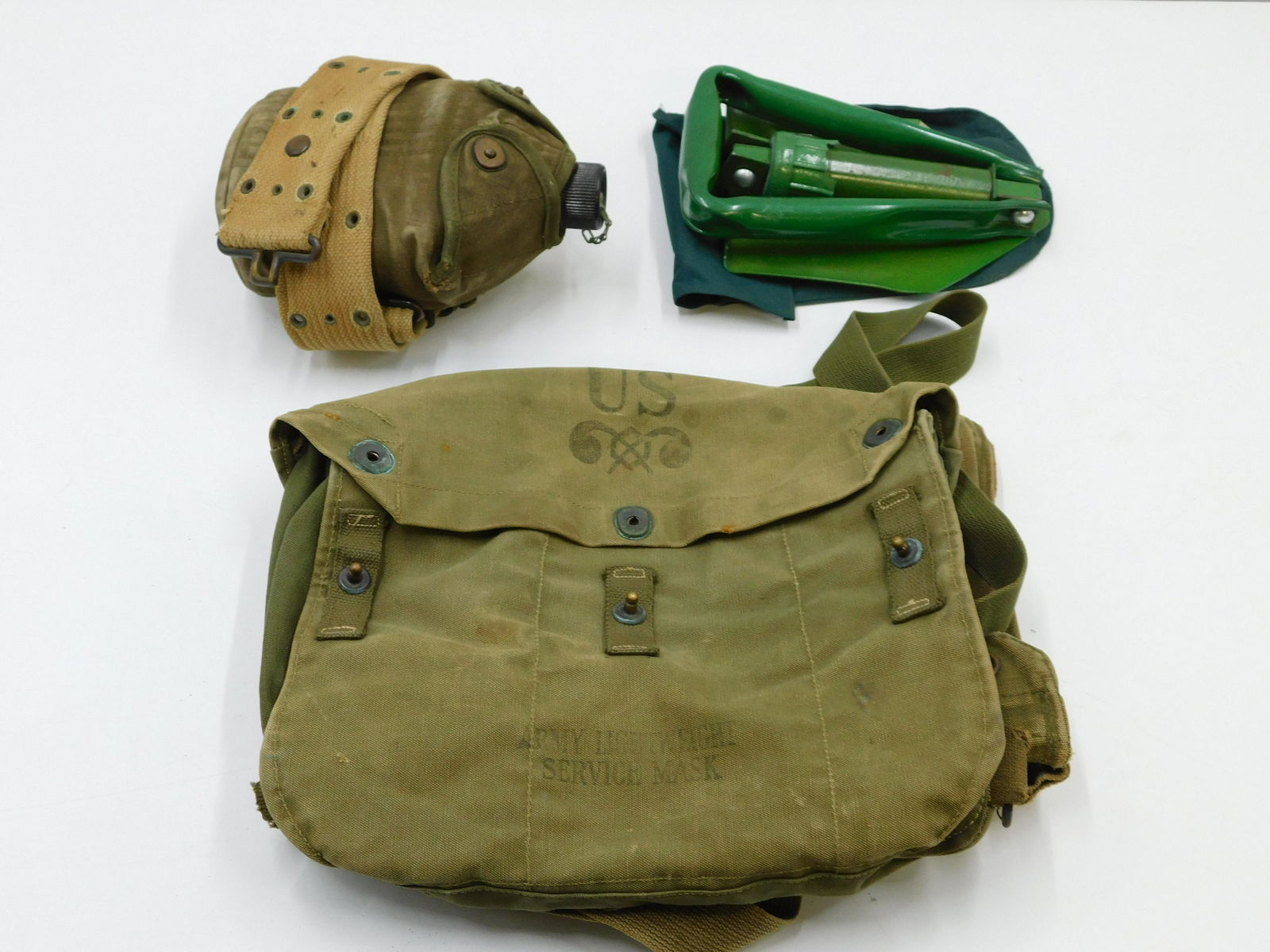 Lot of US Military Issued Equipment: Lot of US Military Issued Equipment including Lightweight Service Mask Bag, Field Protective Mask Bag, Canteen, and Shovel (Unsure if Army Issued). All invoices must be paid within 24 hours of the sal