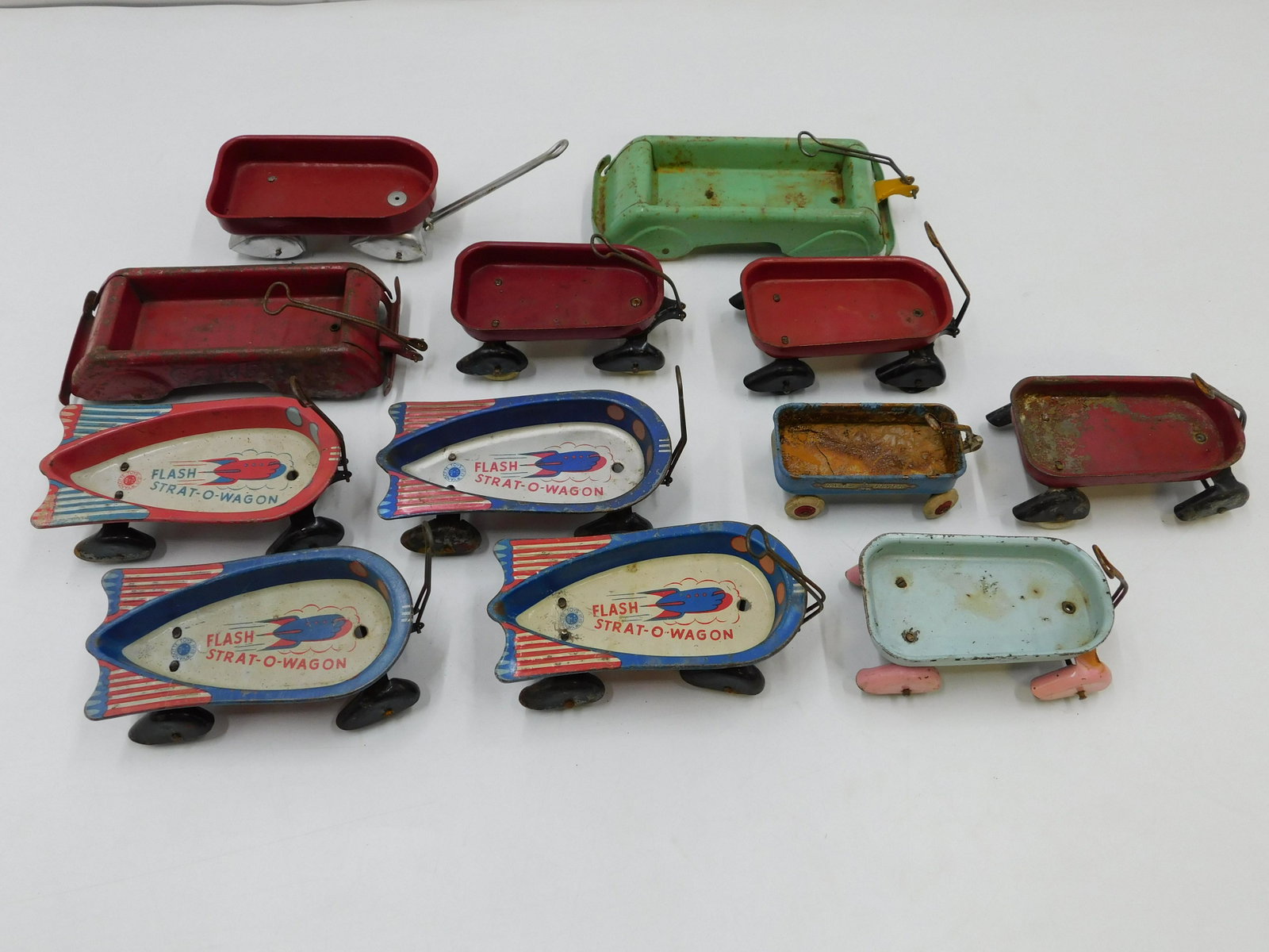 Lot of 12 Miniature Wagons: Lot of 12 Miniature Wagons including (4) Flash Strat-O-Wagons, (2) Comets and More. All Wyandotte. Some are original. Some have been repainted. Some have rusting - one missing wheel. Largest measures 