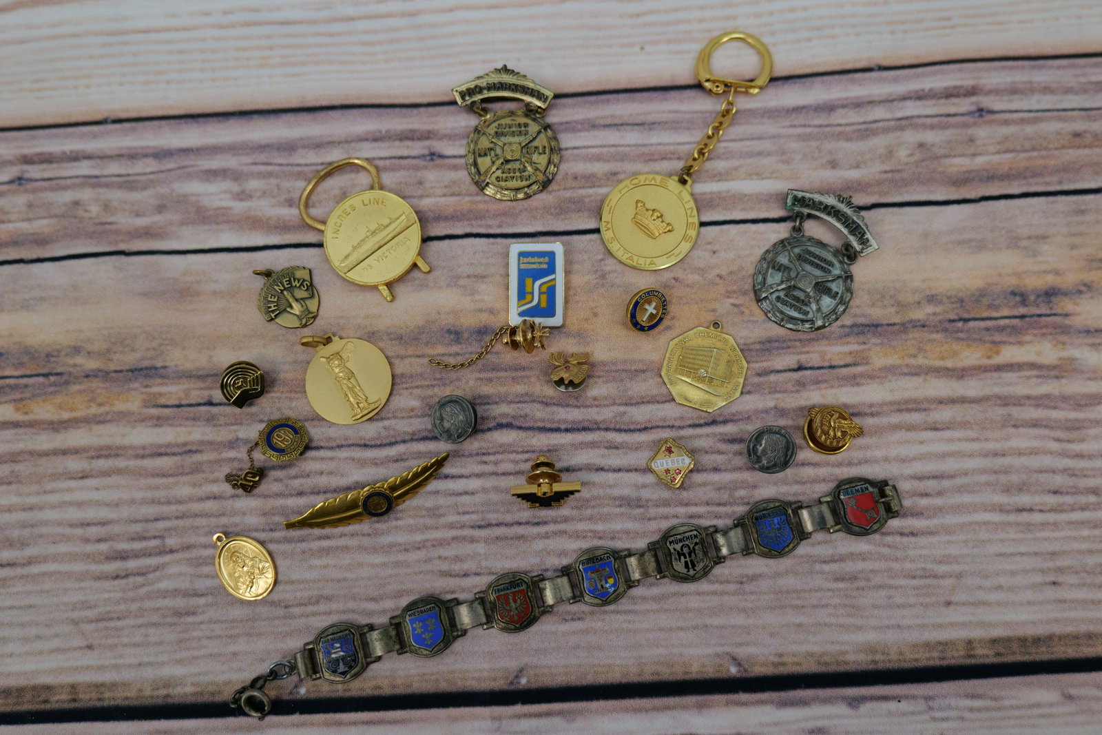 Lot of Men's Jewelry: Lot of Men's Jewelry including Gold Tone and Enamel College Pins, Silver Tone and Enamel German Bracelet (Possibly Military) Marksman Medals, and 1 Gold Filled and Diamond Tie Tac, and 1 Gold Plated a