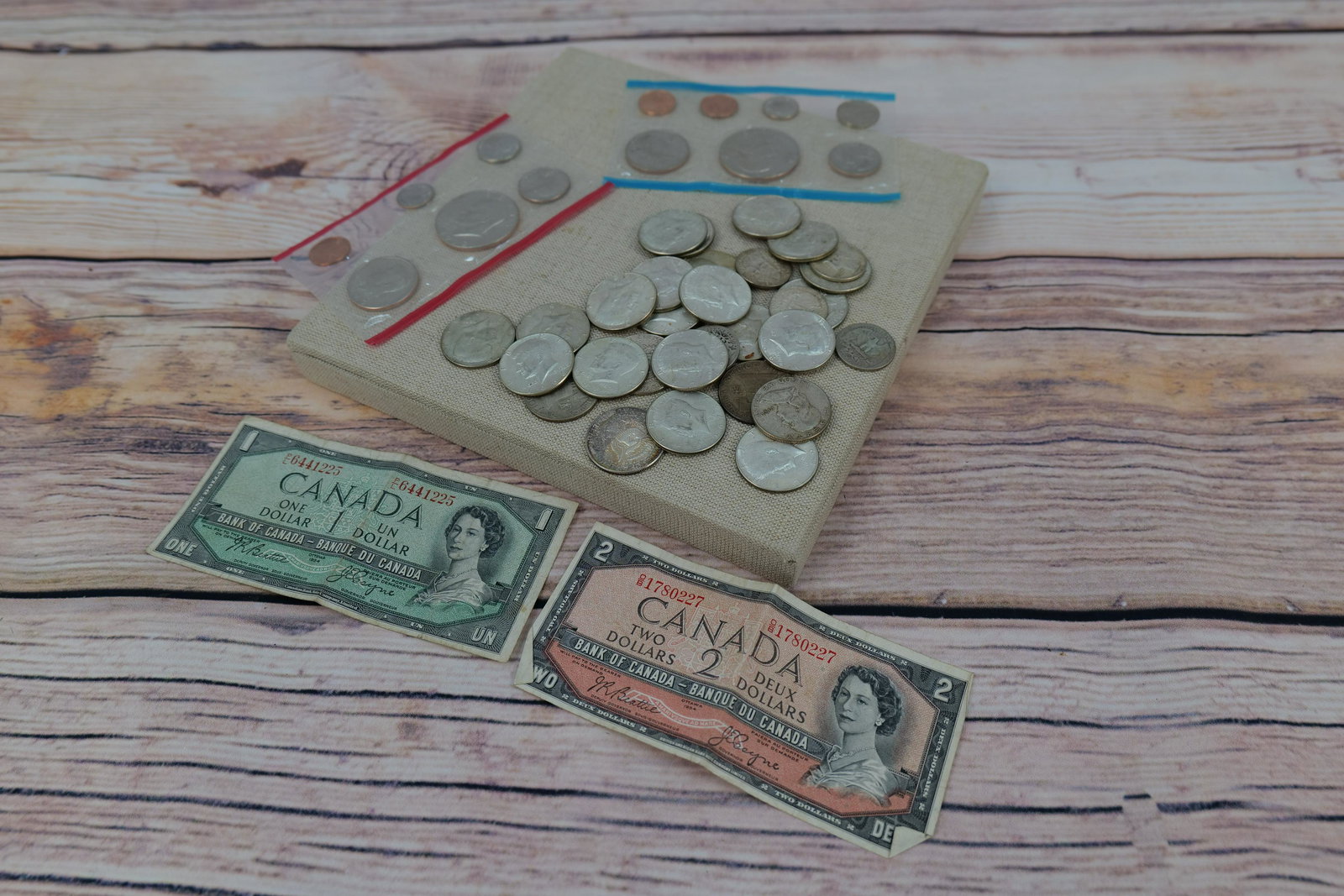 Lot of Currency: Lot of Currency including Canadian Dollars, 1973 Mint Sets, and (5) Kennedy and Franklin Silver 1/2 Dollars, (5) Silver Quarters and (20) Kennedy 40% Clads. All invoices must be paid for within 24 hou