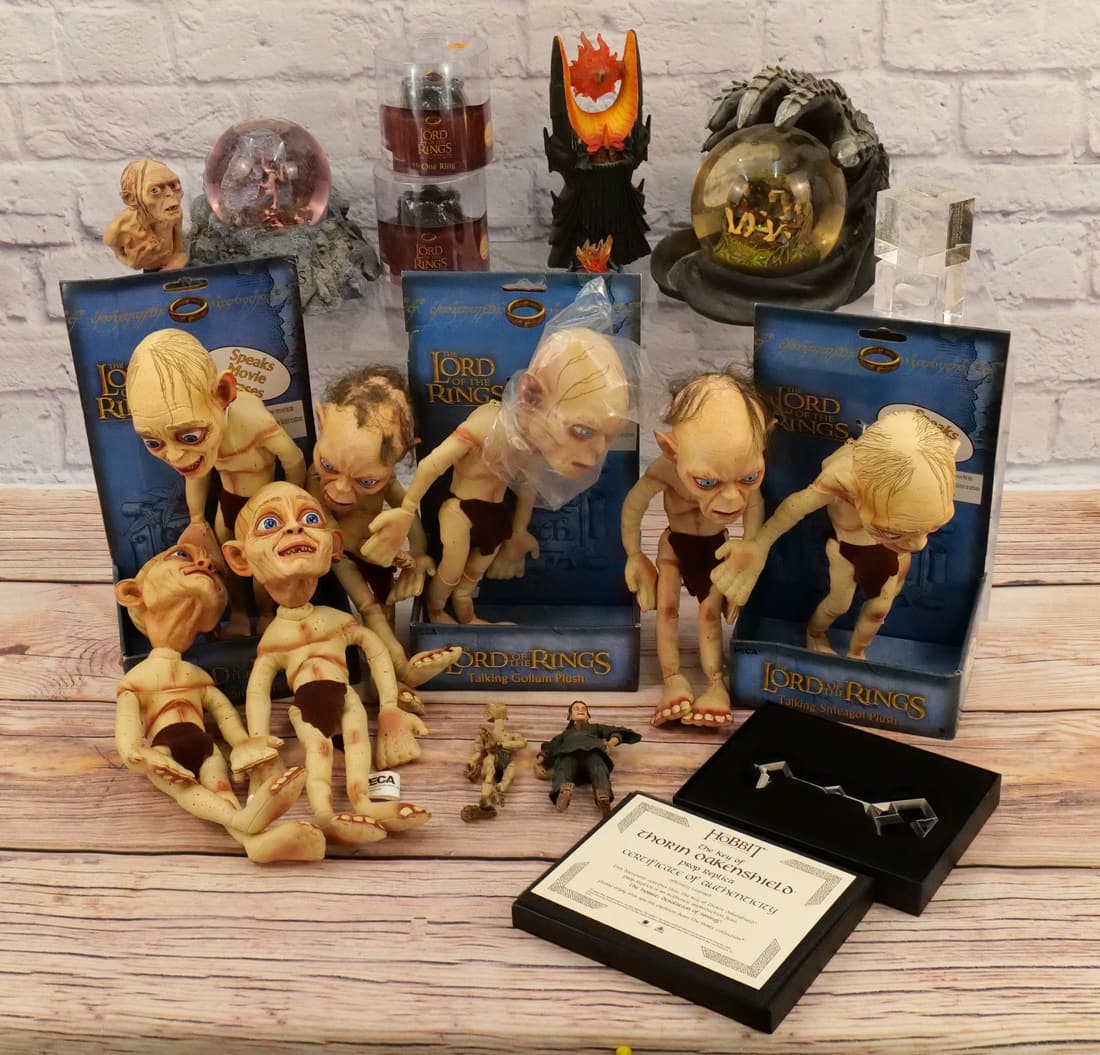 Lot of Lord of the Ring Toys and Collectibles: Lot of Lord of the Ring Toys and Collectibles including Talking Gollum Plush, The One Ring, Sideshow Smeagol Bust - Loose, Water Globes - Some Discoloration, and More. Some items are new and others ar