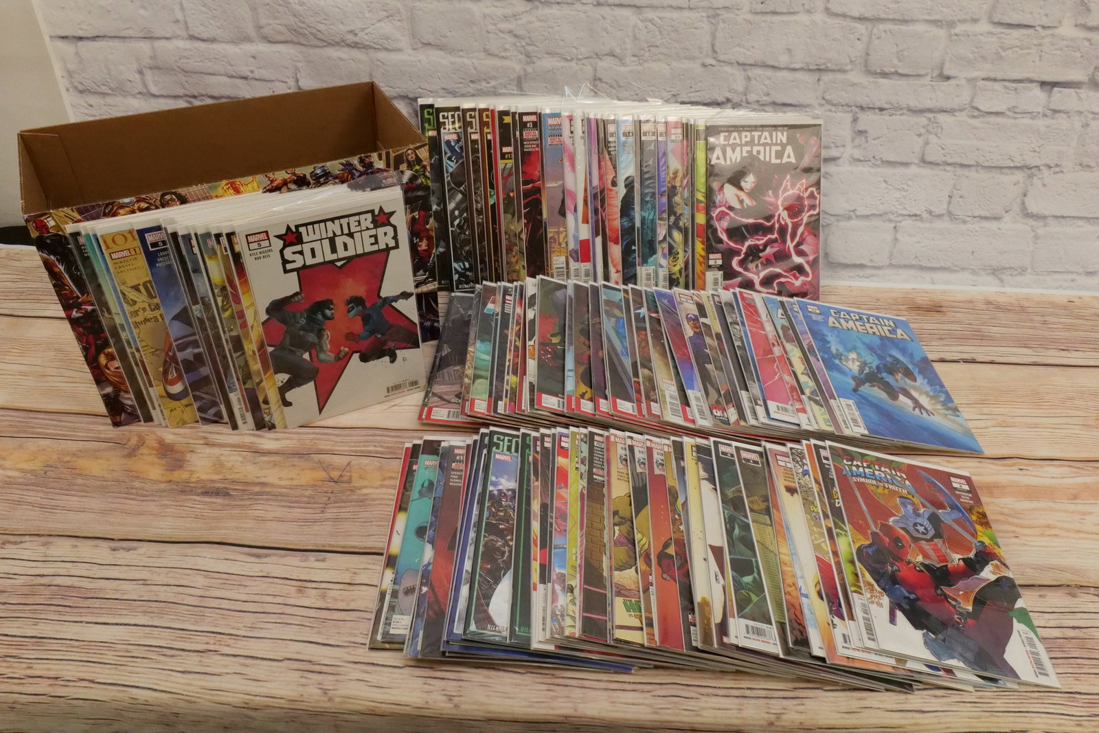 Short Box of Captain America Comics - 2010's-2020's: Short Box of 2010's and 2020's Captain America Comics including Secret Empire, Sentinel of Liberty, Winter Soldier, Falcon and Winter Soldier, Captain Carter, Captain America Iron Man, and More. Comes