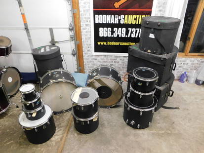 Vintage Ludwig Drum Set: Vintage Ludwig Drum Set. Contains 2 Bass Drums, 8 Toms, and 1 Floor Tom. Floor Tom is missing 3 Feet. Has a leather outer casing. Unsure if original or redone. Comes with 5 Original Ludwig Hard Cases.