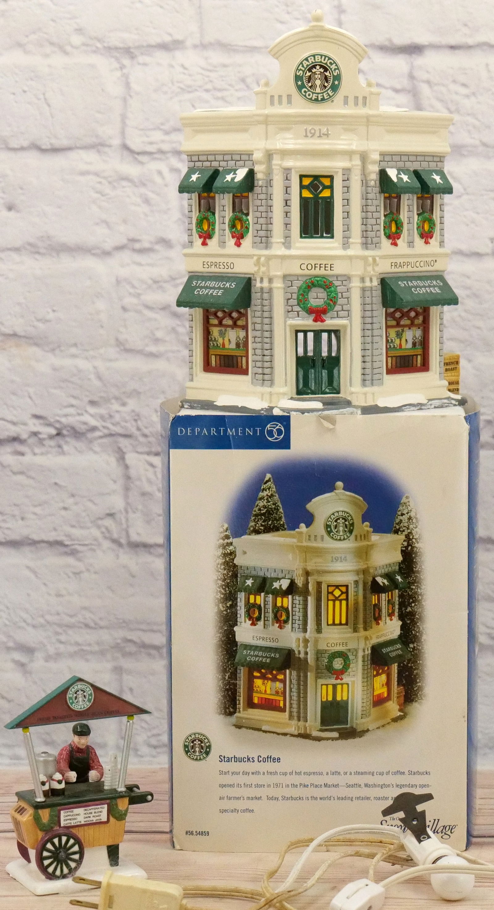 Dept. 56 Snow Village Starbucks Coffee with Accessory: Department 56 Snow Village Starbucks Coffee - Comes with Accessory - Accessory does not have a box. House has minor chips that can not really be seen. All Items in this sale have been on display and a