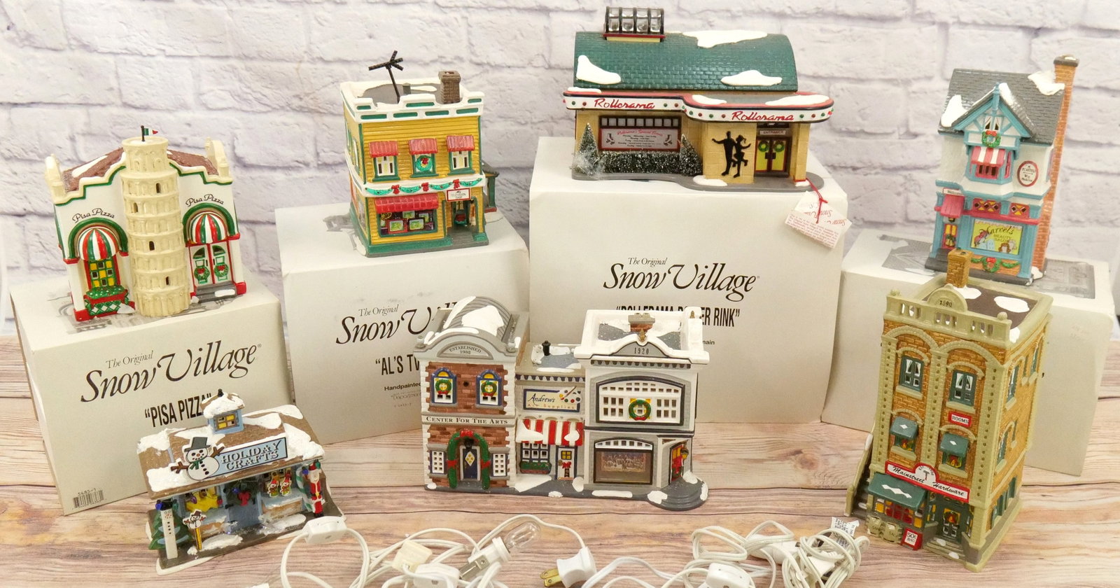 Lot of 7 Department 56 Snow Village Houses: Lot of 7 Department 56 Snow Village Houses including Rollerama Roller Rink, Al's TV Shop - Antenna is loose on roof and some chipping present, Marvel's Beauty Salon, Pisa Pizza - Minor Chips, Holiday 