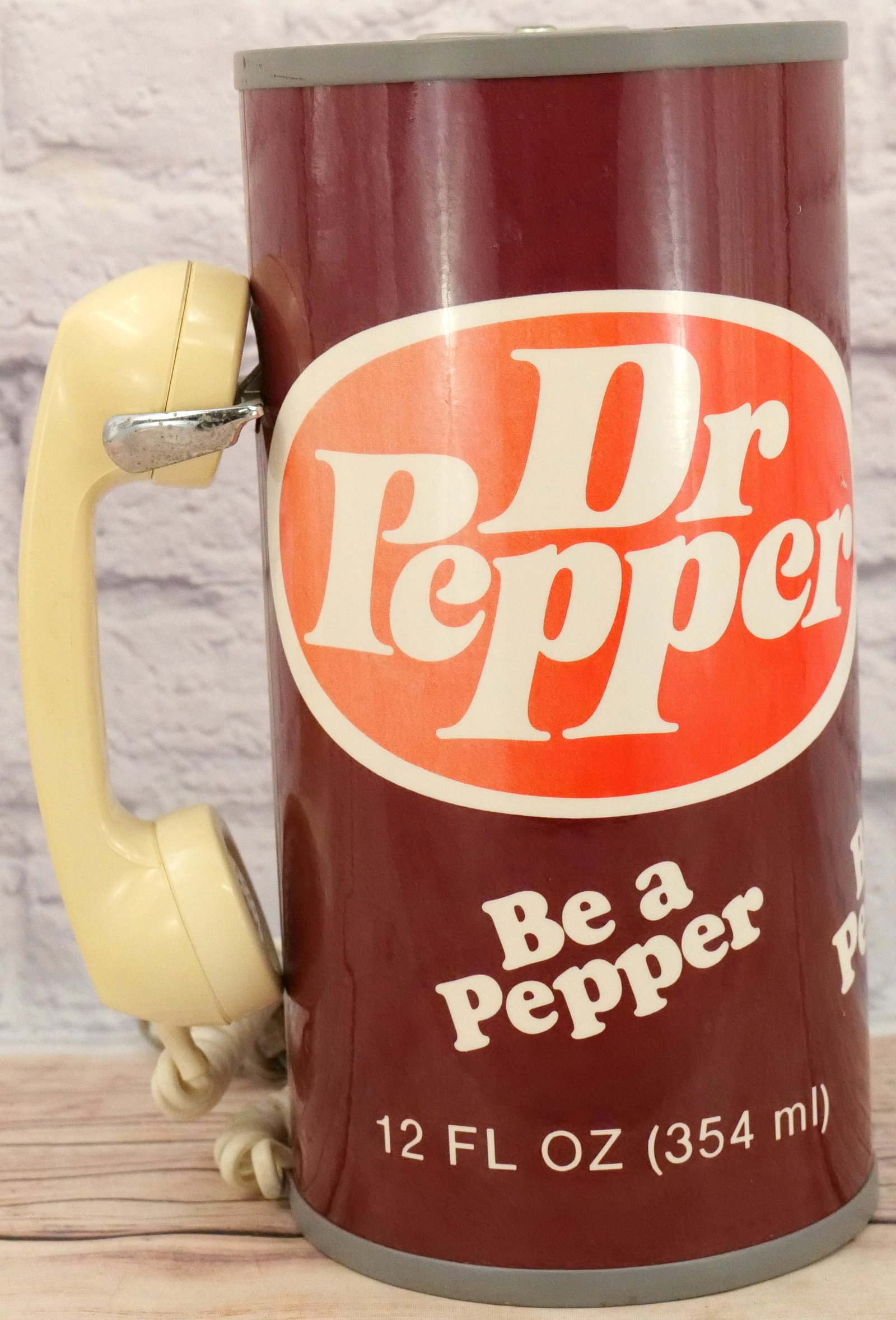 Dr. Pepper Can Novelty Telephone: Dr. Pepper Can Novelty Telephone. Top seems to be stuck and will not open. Some discoloration present. Measures 12.5" tall x 10" wide. Collection was displayed in the house and all items are untested.