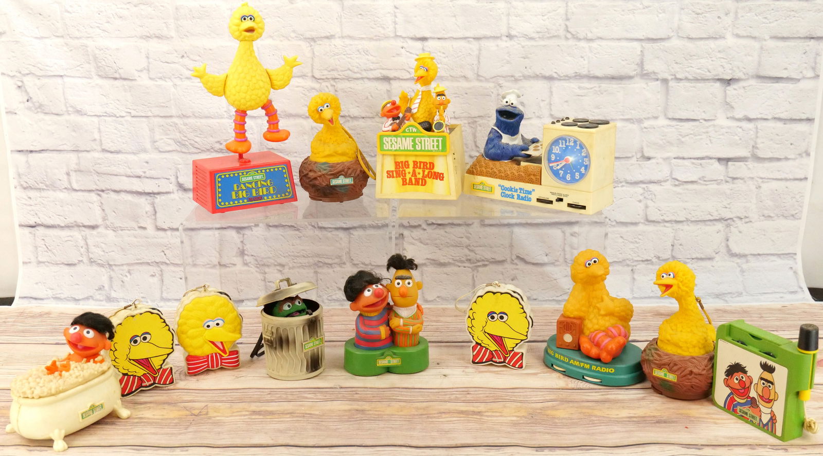 Lot of 13 Sesame Street Novelty Radios: Lot of 13 Sesame Street Novelty Radios including Big Bird Sing Along Band, Dancing Big Bird, Cookie Time Clock Radio, Oscar the Grouch, (2) Bert & Ernie, Ernie in Bathtub, and (6) Various Big Bird Rad