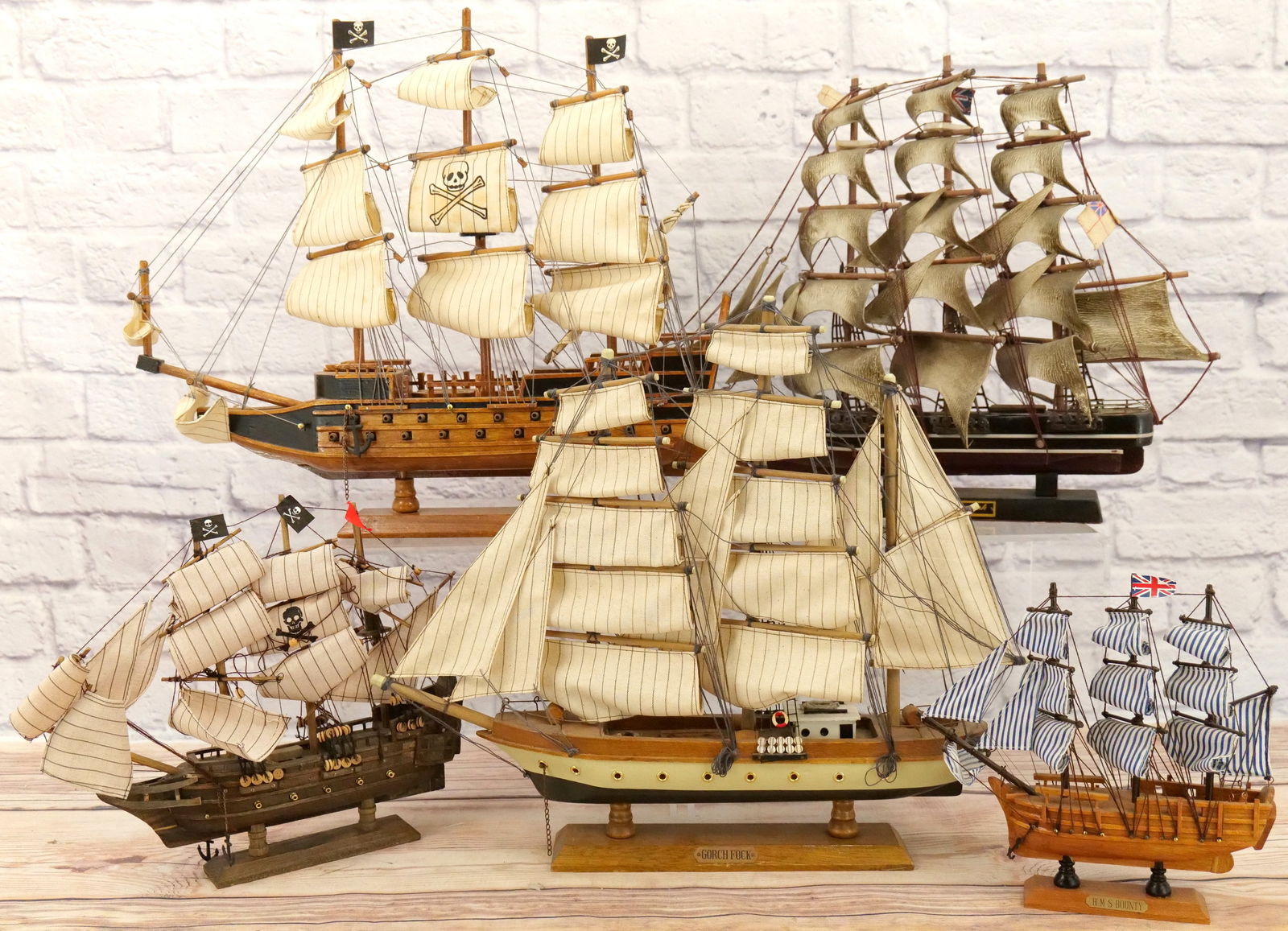 Lot of Wooden Model Ships: Lot of Wooden Model Ships including HMS Bounty, Gorch Fock, Cutty Sark, and 2 Pirate Ships. Sails need a good cleaning. May be missing a few pieces here and there and I did notice a couple of minor br