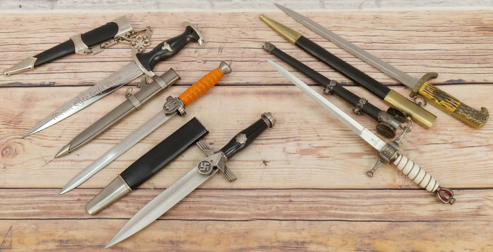 Lot of Fantasy Daggers: Lot of Fantasy Daggers including Third Reich Replica, Eagle Head Handled Dagger, German WWII Replica, German Red Cross Dagger and More. All invoices must be paid within 24 hours of the sale. We offer 