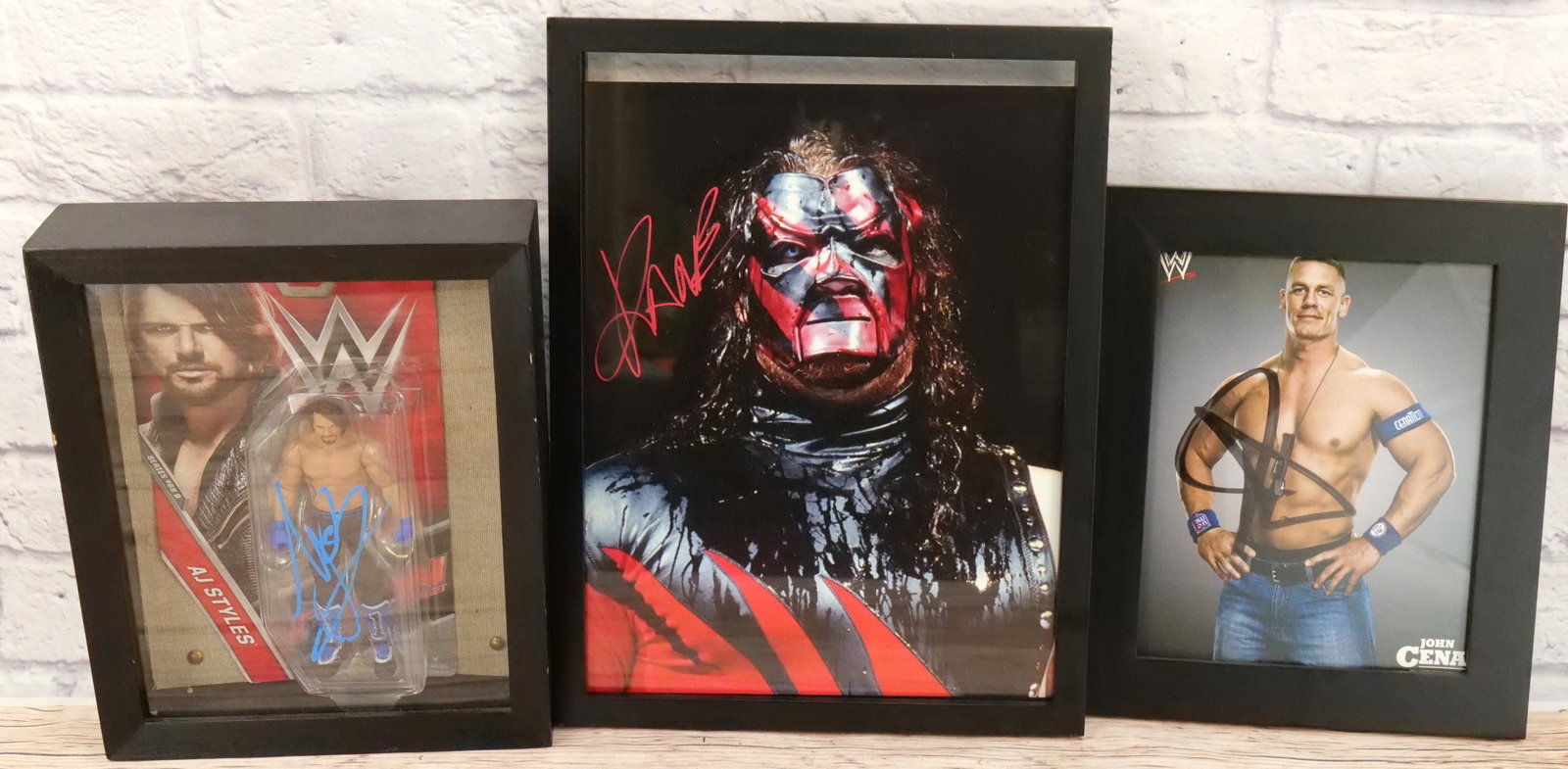 Lot of 3 Wrestling Autographs: Lot of 3 Wrestling Autographs including John Cena, Kane and AJ Styles Action Figure. All framed. Largest measures 16" tall x 12" wide. This autograph comes with a 30 day guarantee. It came from an est