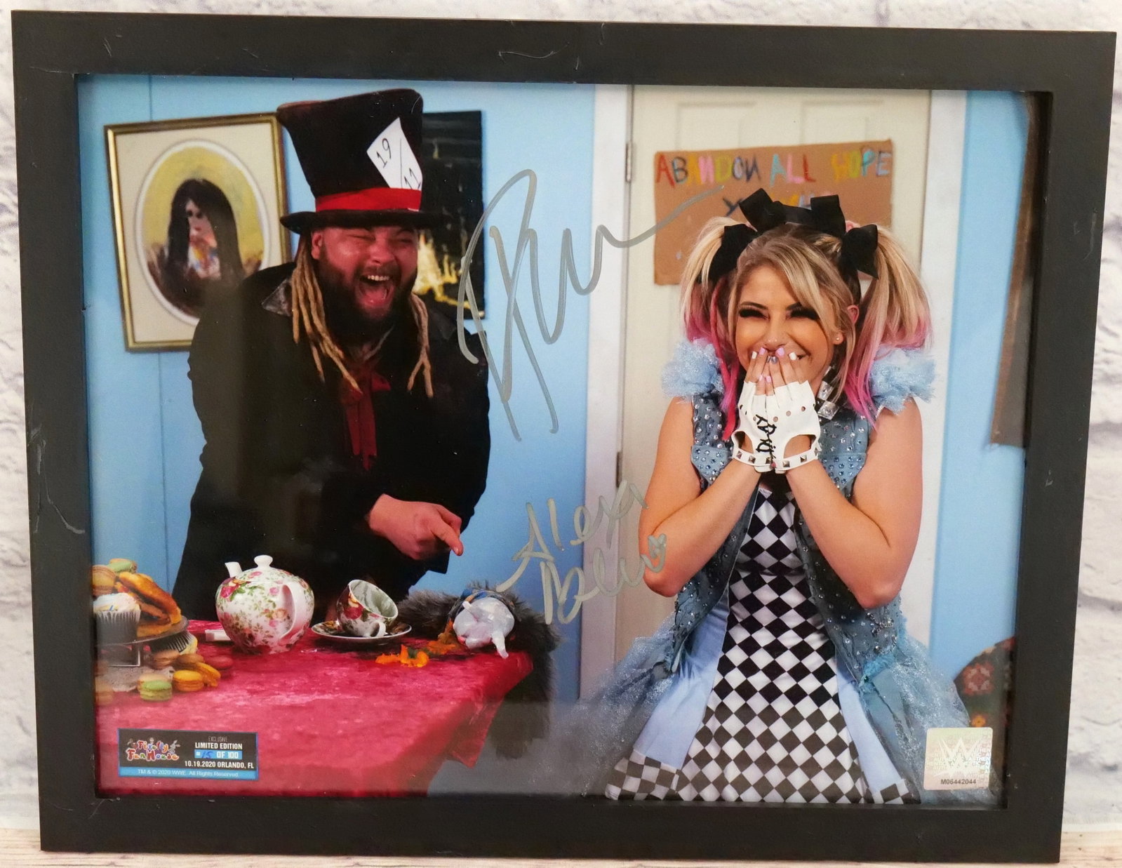Firefly Funhouse Autograph - Alexa Bliss & Bray Wyatt: Firefly Funhouse Autographed by Alexa Bliss and The Fiend Bray Wyatt. Limited Edition #15/100. Has hologram on bottom corner. Framed. Measures 12.5" tall x 15.5" wide. This autograph comes with a 30 d
