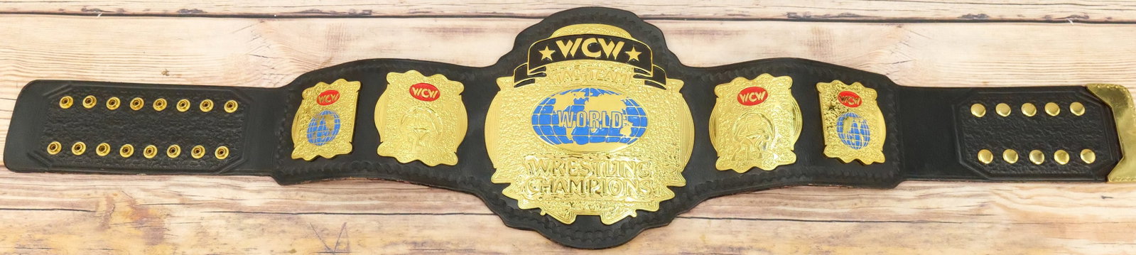 WCW World Tag Team Replica Championship Belt: WCW World Tag Team Replica Championship Belt. Some wear to leather edges. All invoices must be paid for within 24 hours. We offer multiple shipping options, please read the terms as they have changed.