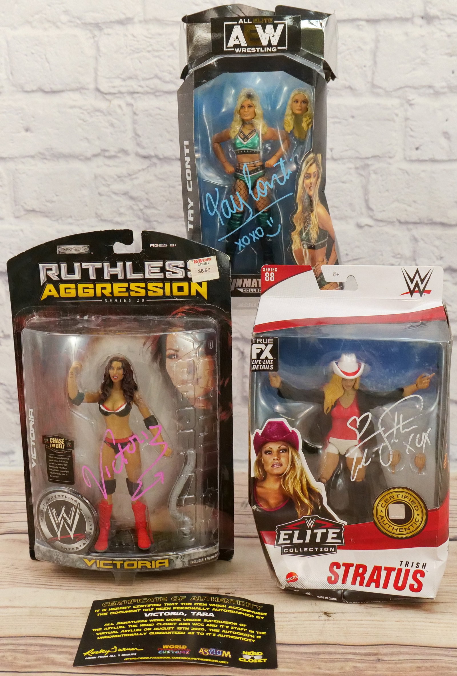 Lot of 3 Autographed Female Wrestling Figures: Lot of 3 Autographed Female Wrestling Figures including AEW Tay Conti - Damaged Box, WWE Elite Trish Stratus - Damaged Box, and Jakks Ruthless Aggression Victoria with COA - Box has wear. All invoices