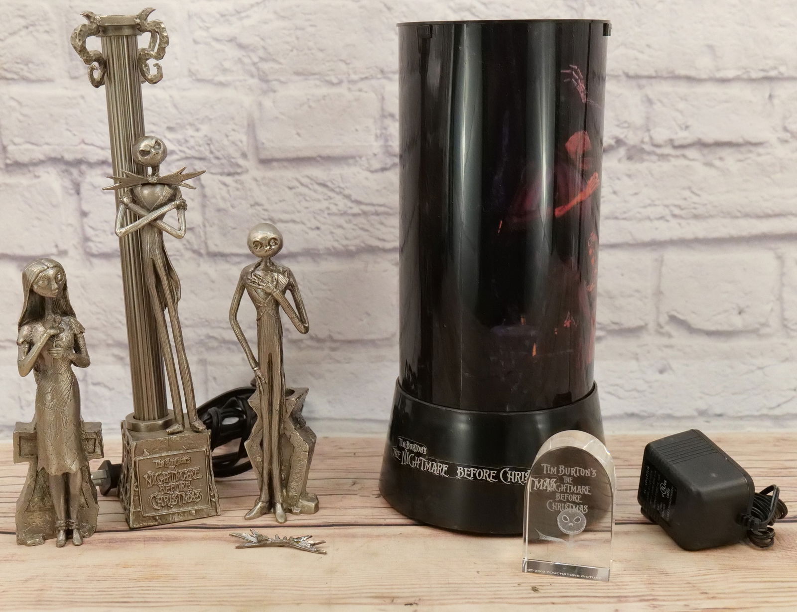 Lot of Nightmare Before Christmas Collectibles: Lot of Nightmare Before Christmas Collectibles including Jack and Sally Candlestick Holders, Jack Lamp, Rotating Light, and Paperweight. Jack's bowtie has come off the candlestick - Piece is included.