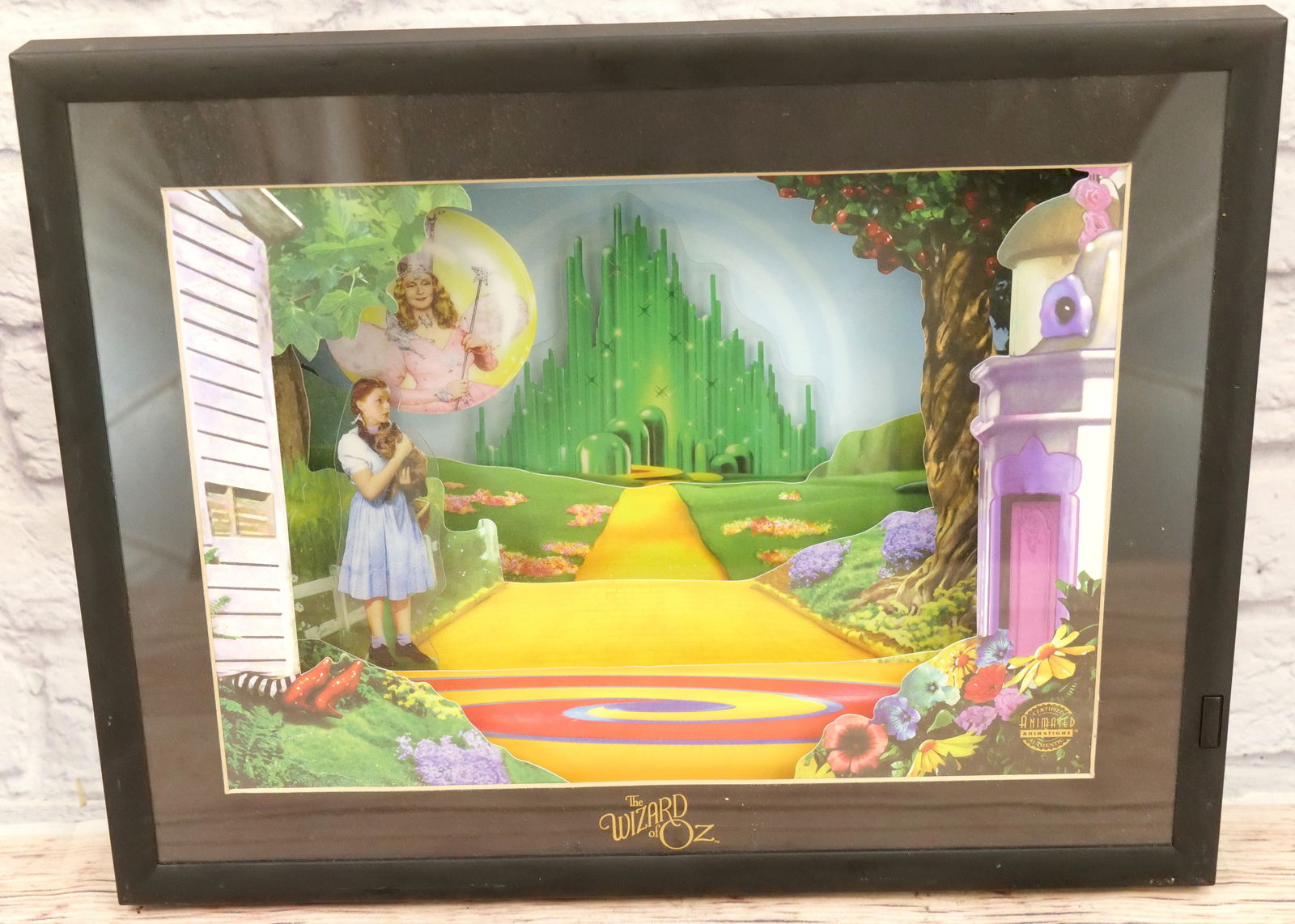 The Wizard of Oz Animated Animations: The Wizard of Oz Animated Animations. Tested - Partially Working. Only does the 1st scene then stops. Could use a good cleaning. Some scuffing to frame. Measures 13.5" tall x 17.5" wide. All invoices
