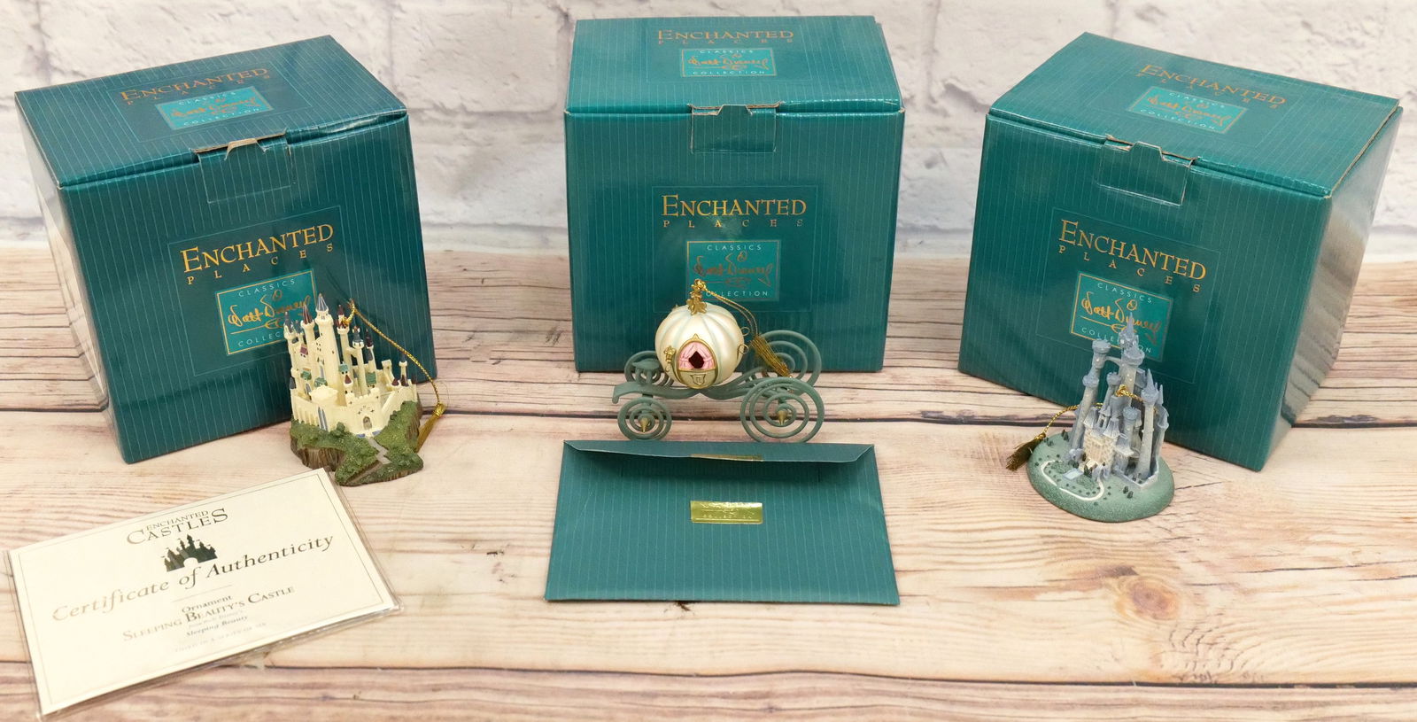 Lot of 3 WDCC Ornaments: Lot of 3 WDCC Ornaments including Enchanted Castles - "Sleeping Beauty's Castle", Enchanted Castles - "Cinderella's Castle", and Enchanted Places "An Elegant Coach for Cinderella" Ornament. All come i