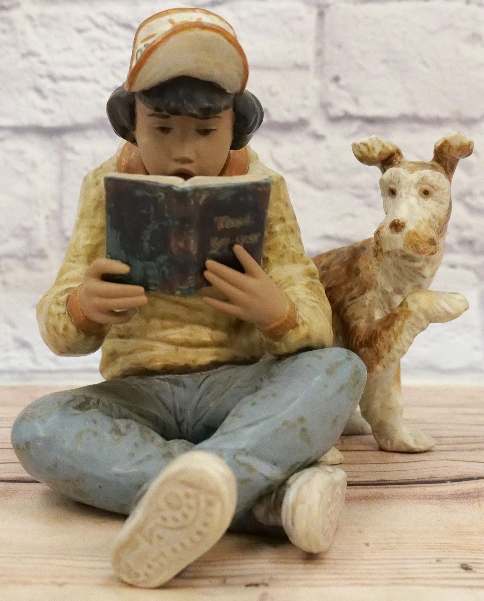 Lladro Learning Together Figurine: Lladro Learning Together Figurine - #2238 - Matte Finish. Depicting Boy reading Tom Sawyer Book with Dog. Measures 7.5" tall x 9" long. All invoices must be paid within 24 hours of the sale. We offer 