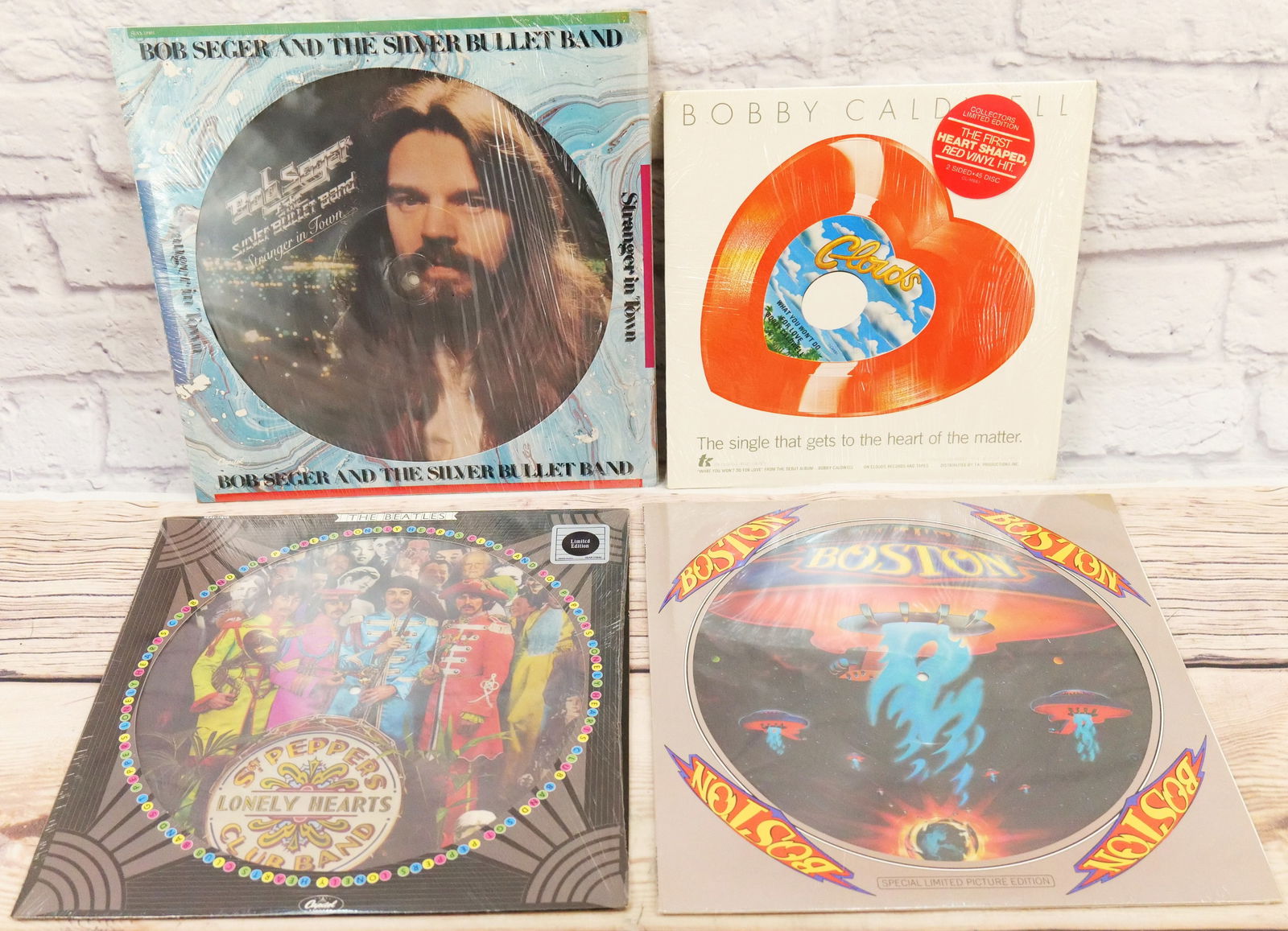Lot of 4 Vinyl Records: Lot of 4 Vinyl Records including Sgt. Peppers Lonely Hearts Club Band Picture Disc - Limited Edition, Boston Picture Disc - Sealed, Bob Sieger and the Silver Bullet Band Picture Disc, and Bobby Caldwe