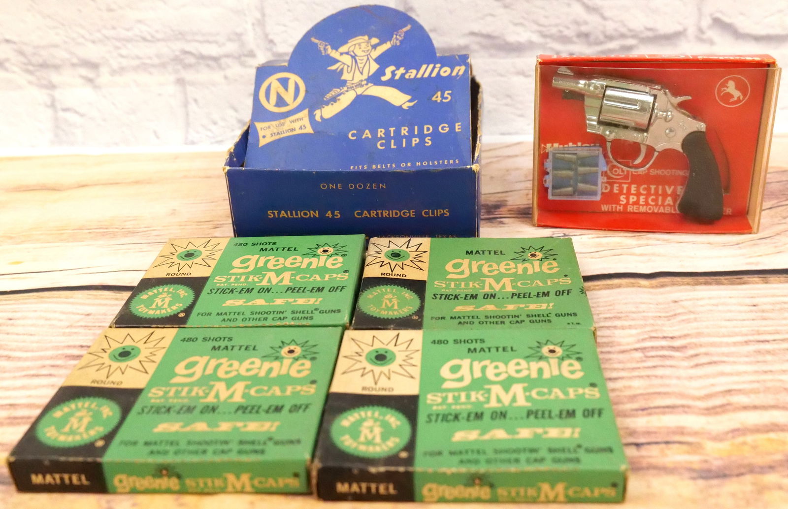 Cap Gun Lot: Cap Gun Lot. Contains Hubley Colt Detective Special in Original Package, (4) Sealed Mattel Greenie Stik-M-Caps, and Empty Stallion 45 Cartridge Clips - Box Only. All invoices must be paid within 24 ho