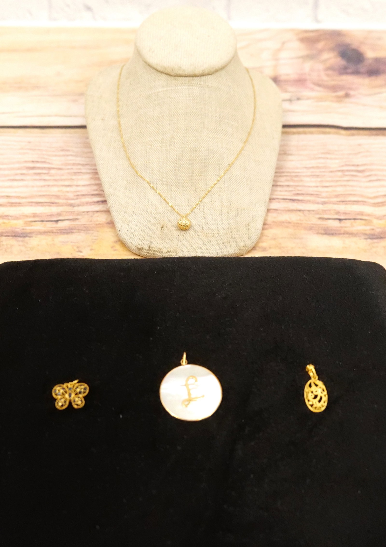 Lot of 18k Jewelry: Lot of 18k Jewelry including Rope Necklace with Diamond Cut Pendant, Filagree and Blue Stone Butterfly, L Monogram Mother of Pearl Pendant and Textured Filagree Style Pendant. Some tested and some are