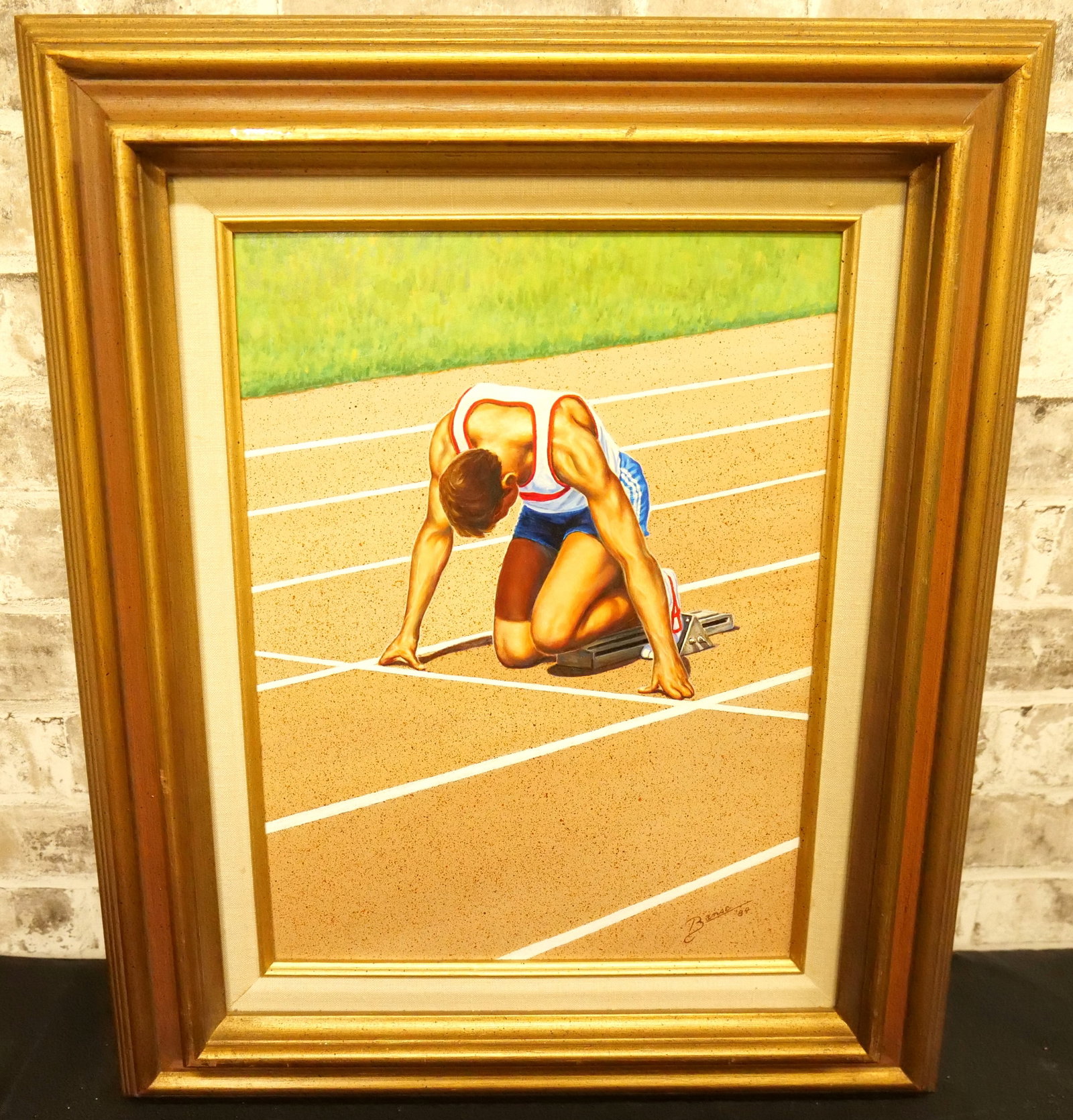 In the Blocks by Glen Fortune Banse: Original Oil on Board by Glen Fortune Banse (1948-2018). Entitled "In the Blocks" Depicting a Runner at a Track Event. Signed Lower Right. Dated '84. Sticker on back gives the name of the artwork. Mea