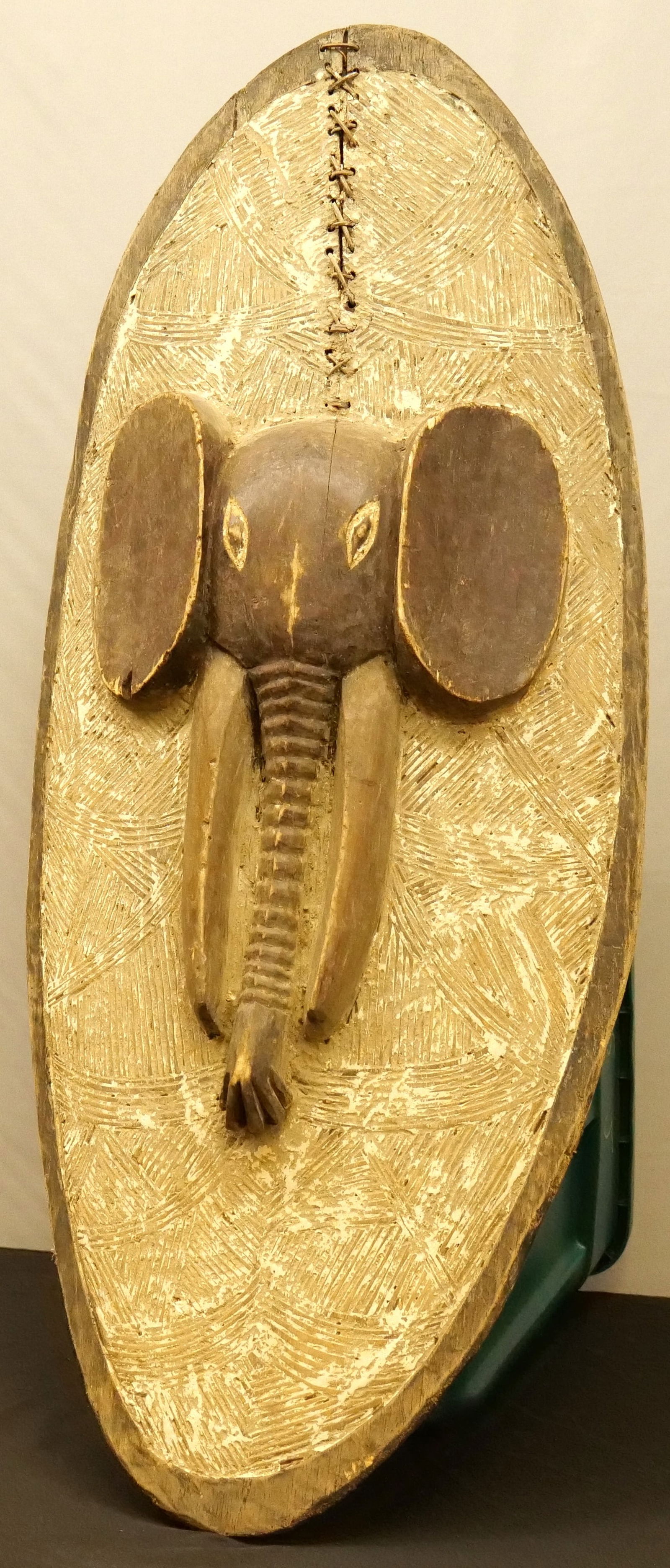 African Tribal Art Ceremonial Shield: African Tribal Art Ceremonial Shield. Depicting an Elephant in the Center. Not sure of age. At least 50+ years. Measures 47" long x 22" wide. All invoices must be paid within 24 hours of the sale. We