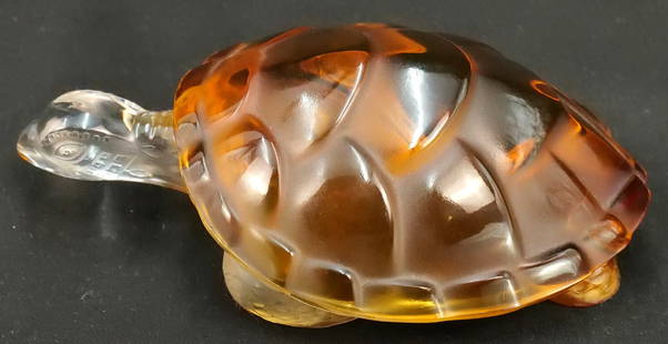 Lalique Turtle: Lalique turtle figurine with an amber shell. Measures 2 1/2" tall x 6" wide. All invoices must be paid within 24 hours of the sale. We offer multiple shipping options, please read the terms as they ha