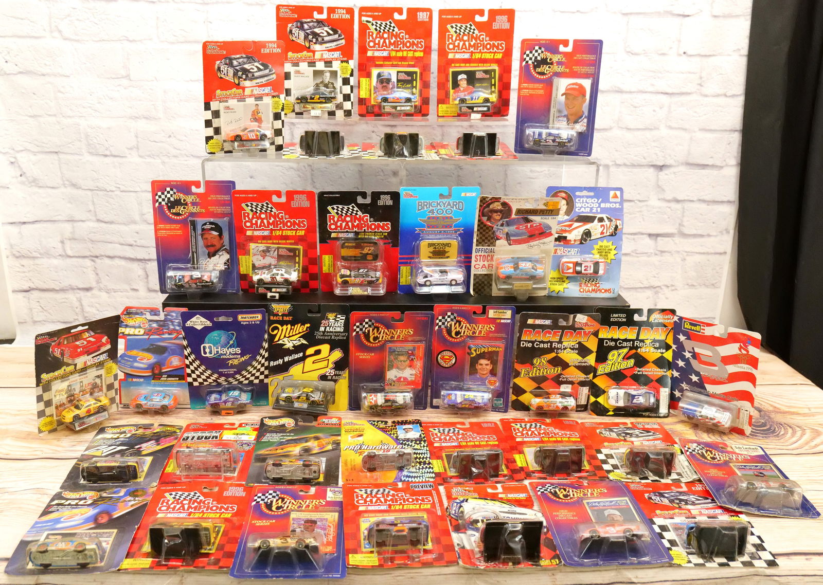 Lot of 35 Nascar Diecast Cars - 1:64 Scale: Lot of 35 Nascar Diecast Cars - 1:64 Scale. Mostly from the 90's. Includes Racing Champions, Winner's Circle, Hot Wheels Racing, and Revell. All sealed on card. Cards have some wear. All invoices must