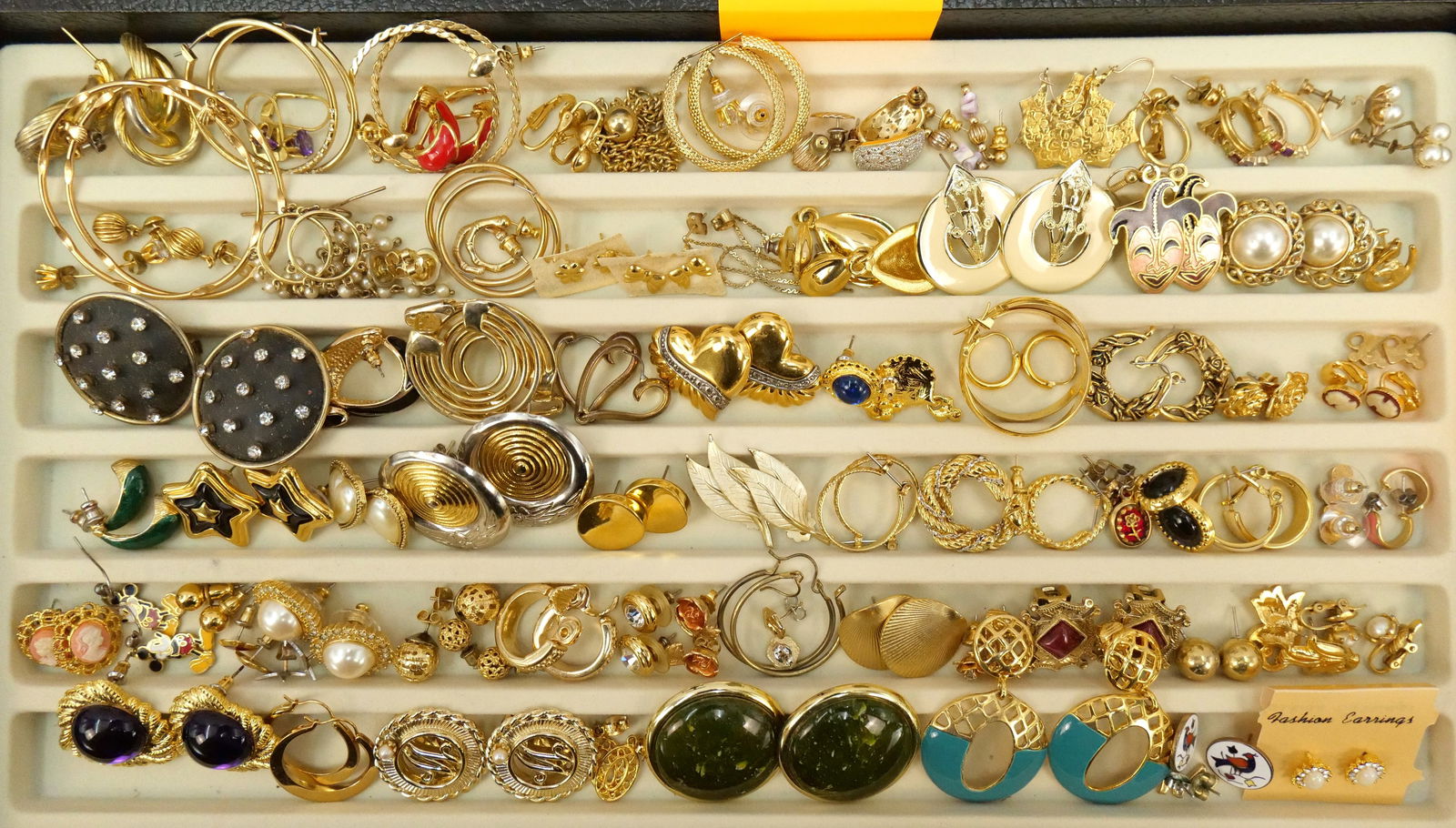 Lot of Gold Tone Costume Earrings: Lot of Gold Tone Costume Earrings. Including many modern style hoops, enamel, and more. All invoices must be paid within 24 hours of the sale. We offer multiple shipping options besides the Liveauctio