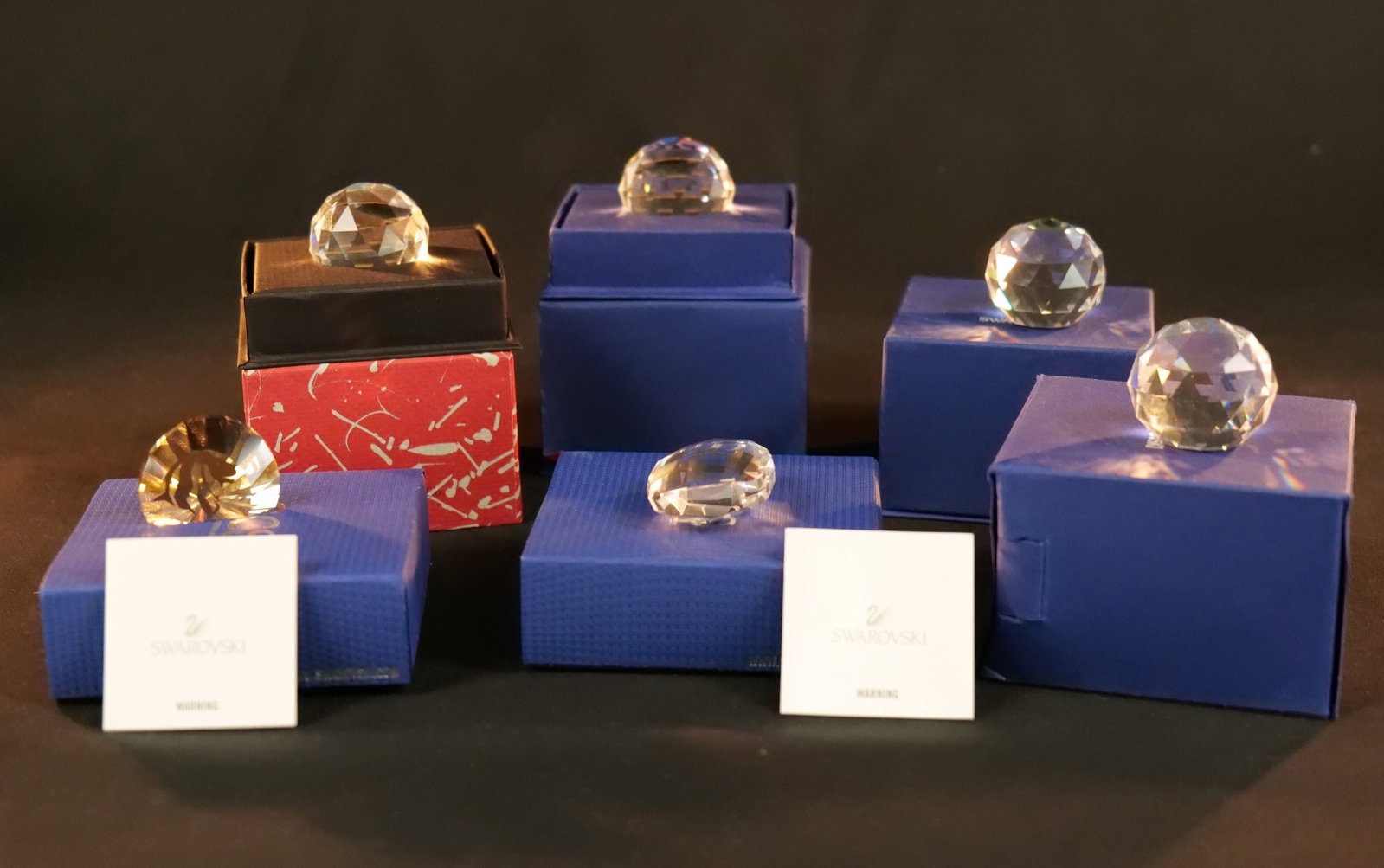 Lot of 6 Swarovski Crystal Paperweights: Lot of 6 Swarovski Crystal Paperweights. Including Akili Lion Head, Esperanza Horse (Small Chips), Judaica "Life", Australia, Kangaroo, and Blue Lagoon Iceland. All paperweights come in the original b